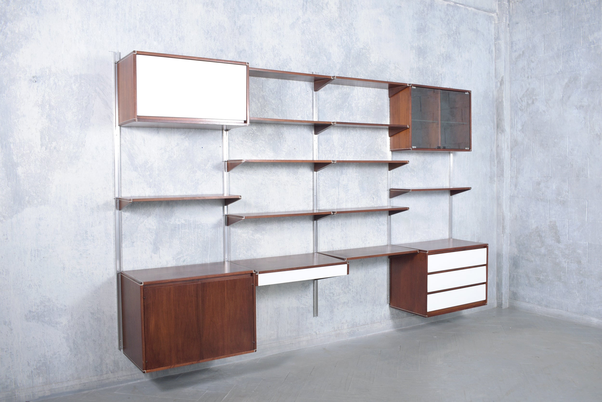 Journey back to the 1960s with our Danish modern bookshelf masterfully handcrafted from mahogany and in excellent condition. Skillfully restored and refinished by our expert craftsmen, this piece now boasts a rich walnut stain with white and black