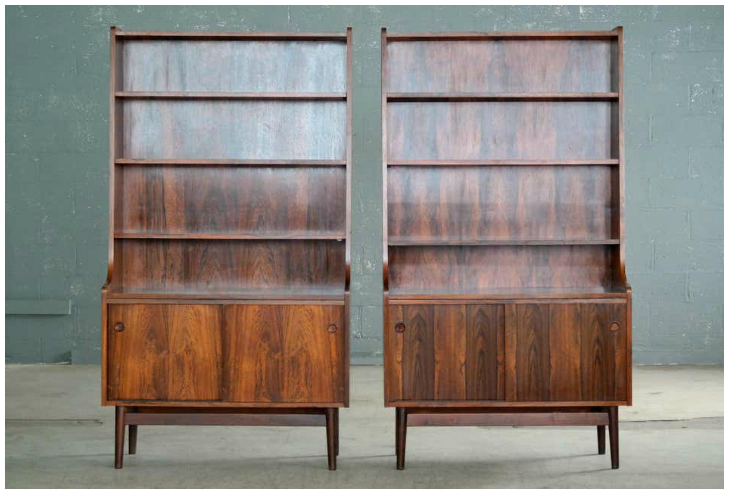 Beautiful and elegant pair of bookcases in bookmatched rosewood with beautiful slightly faded color and rich grain. Designed by Johannes Sorth for Bornholm's Mobler also known as Nexoe Teak. Very versatile with adjustable shelves and two storage