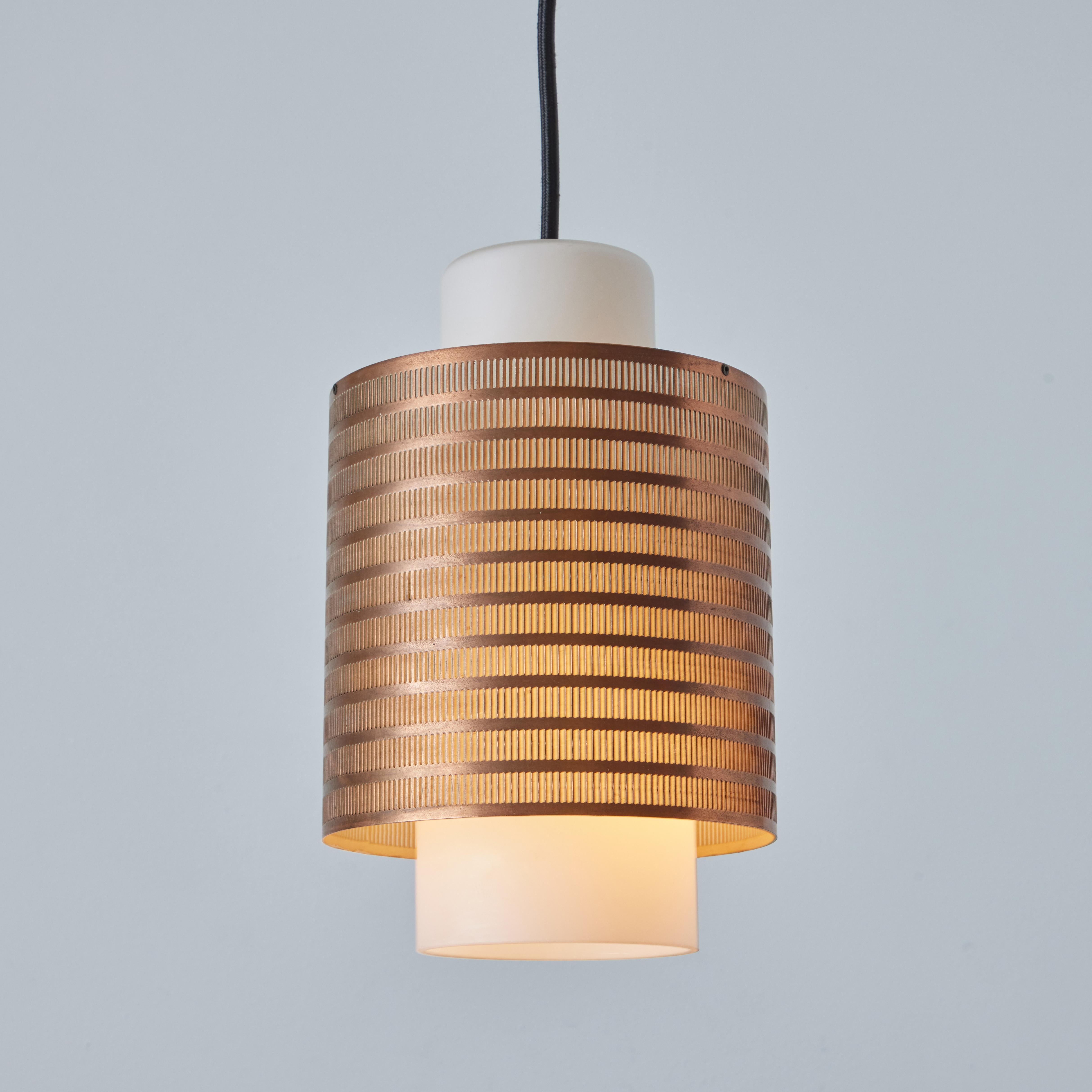 1960s Danish Modern perforated copper and glass pendant attributed to Lyfa. Executed in a subtly patinated perforated copper shade with a blown opaline glass diffuser, Denmark, circa 1960s. A quintessentially Scandinavian pendant of attractive scale