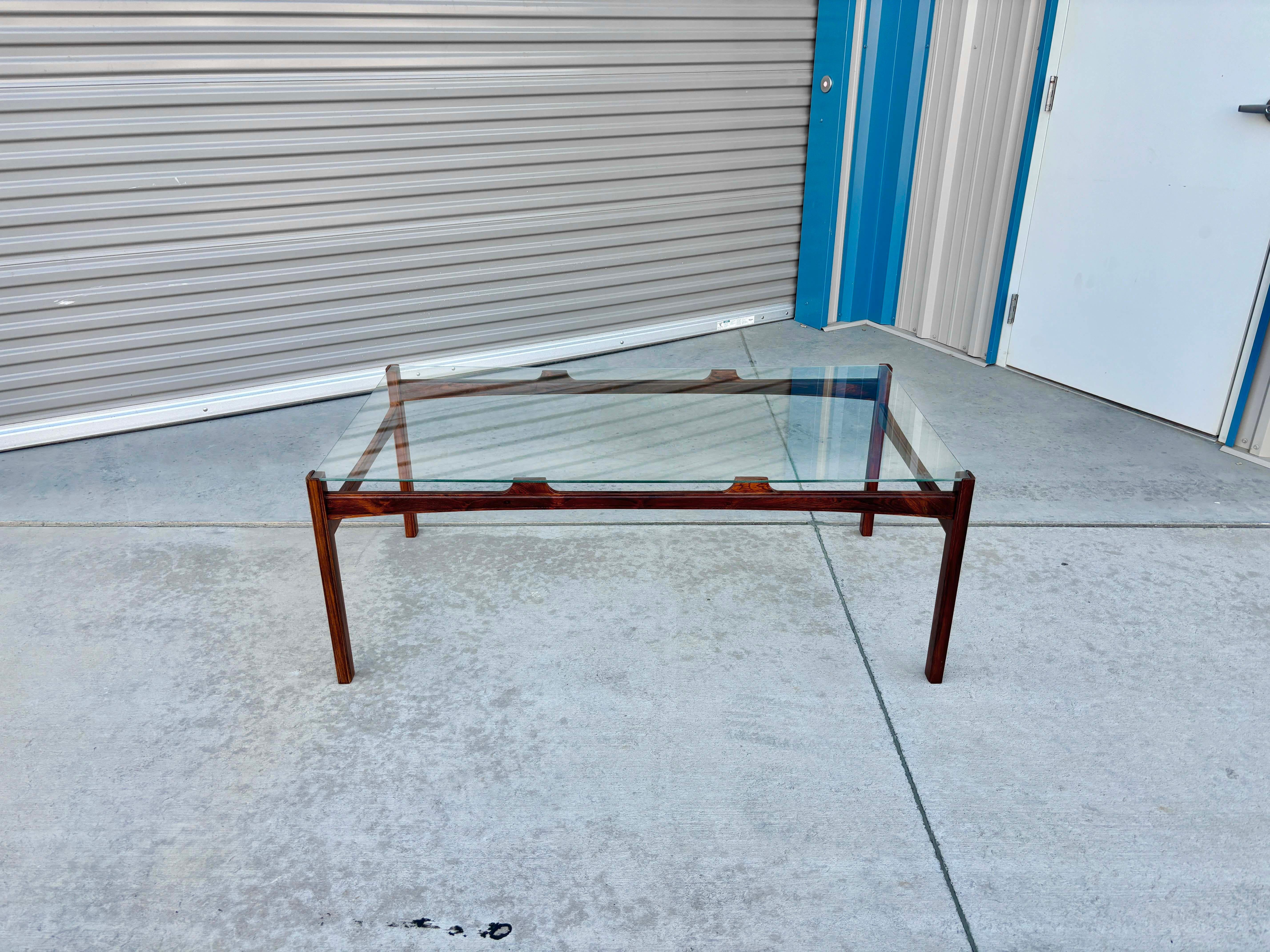 ✨ Danish Modern Rosewood & Glass Elegance ✨

This vintage Danish Modern coffee table is a striking blend of clean lines, rich materials, and timeless craftsmanship. The rectangular glass top rests securely on a newly refinished rosewood base,