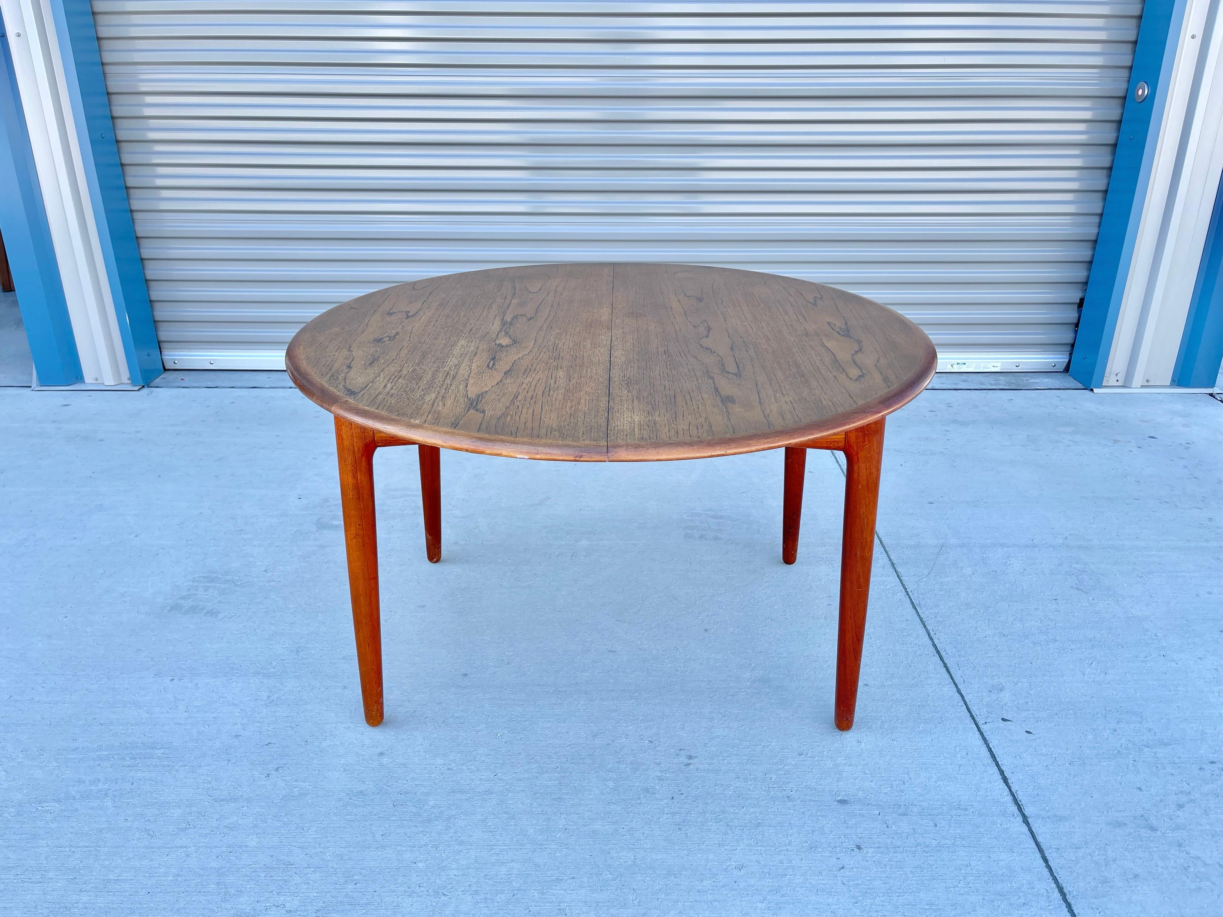 Danish modern teak dining table designed and manufactured in Denmark circa 1960s. This fantastic dining table features a teak frame that gives an excellent color tone and a beautiful grain pattern creating a refined and elegant look. The dining