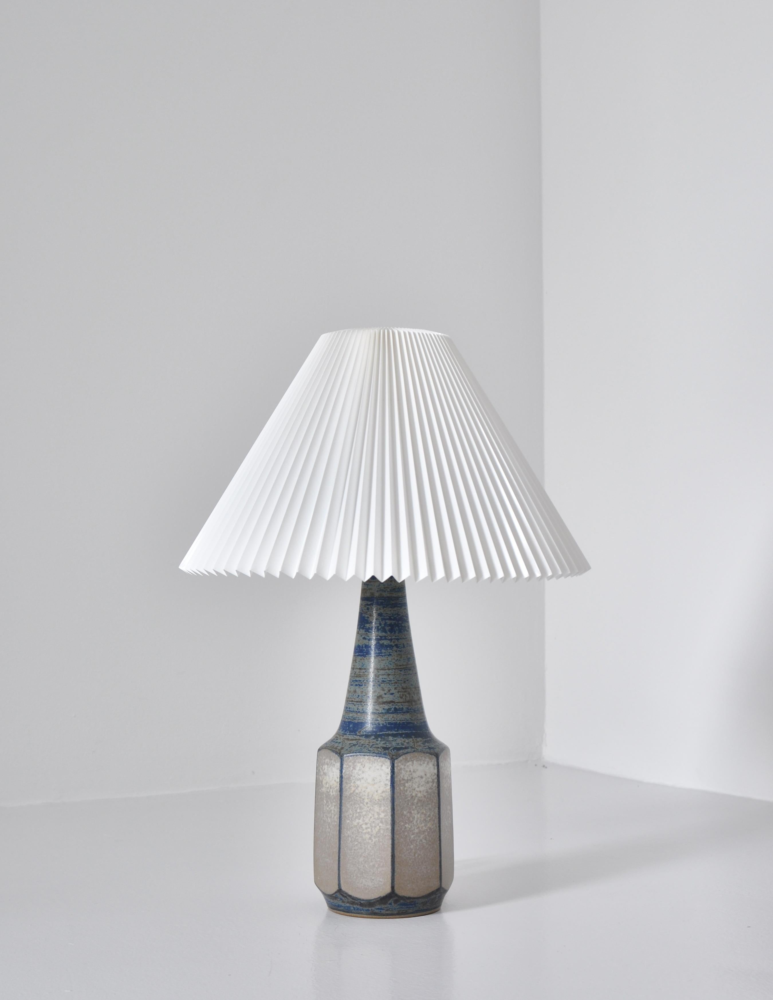 Elegant handmade table lamp made from blue / grey glazed stoneware by Marianne Starck at the workshop of Michael Andersen & Sons, Denmark in the 1960s. The lamp is mounted with a hand folded Le Klint shade. Great condition with no chips, cracks or