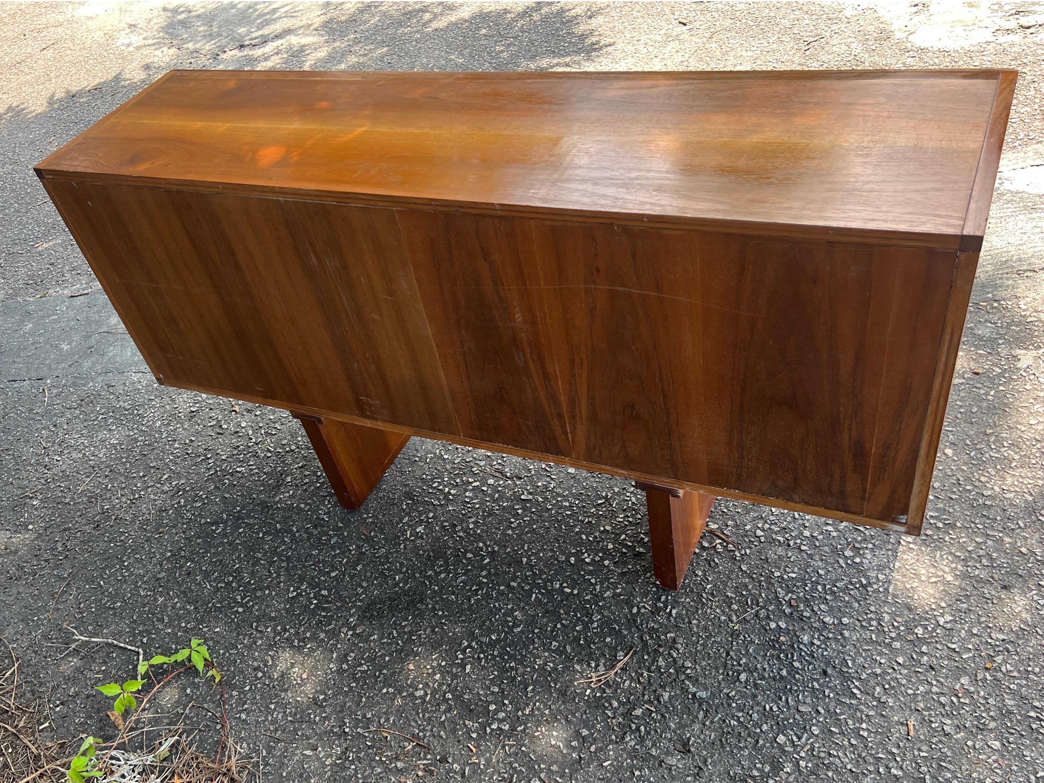 Lovely vintage Mid Century Modern teak bookcase/display or media console with sliding glass doors.   Would look great as an entryway console or media cabinet.   Oh and the best part is that it’s finished on the back.