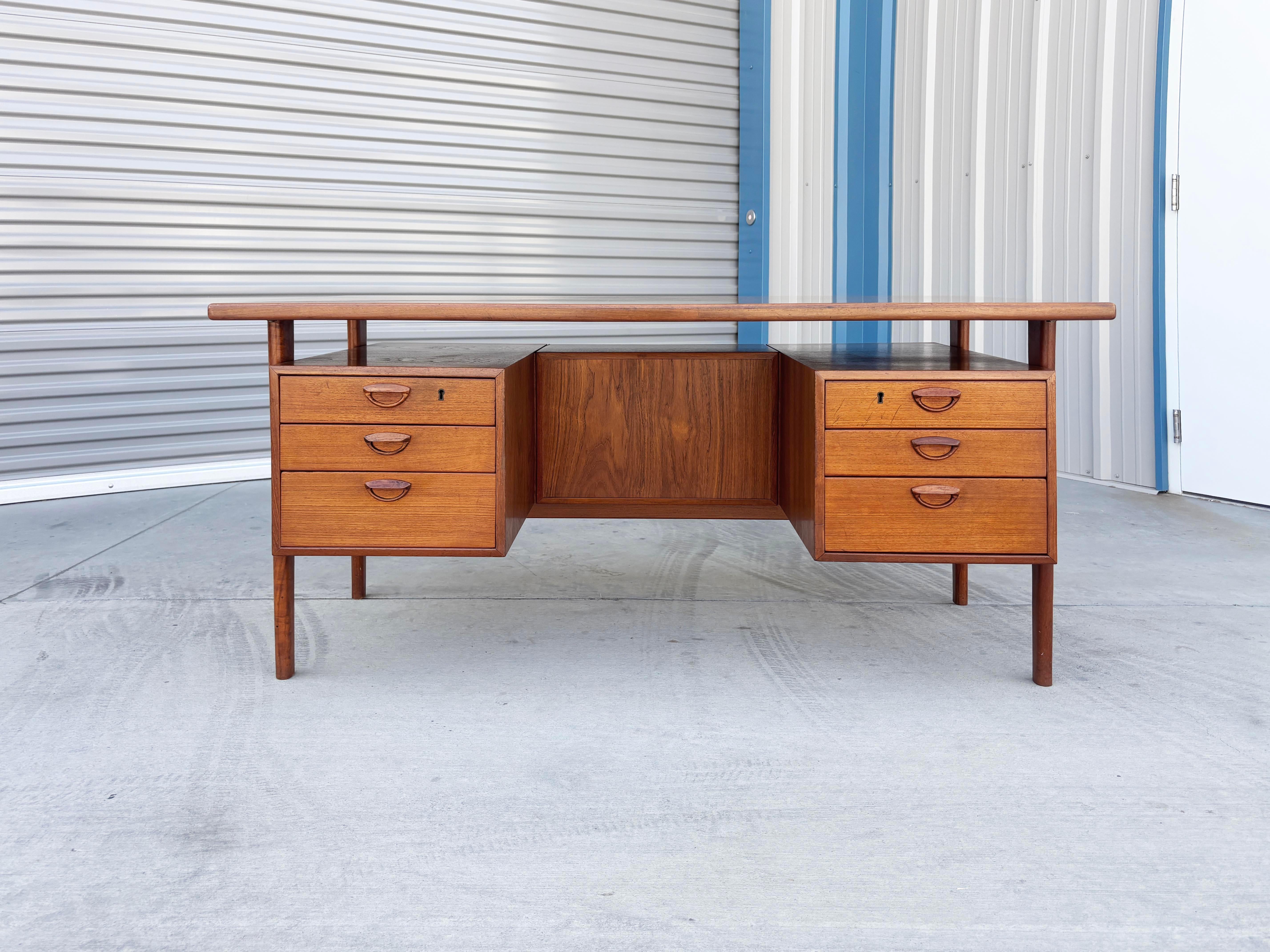 ✨ Mid-Century Danish Modern Teak Executive Desk by Kai Kristiansen ✨

This outstanding mid-century executive desk, designed by celebrated Danish designer Kai Kristiansen, is a masterclass in form and function. Crafted in richly grained teak, the