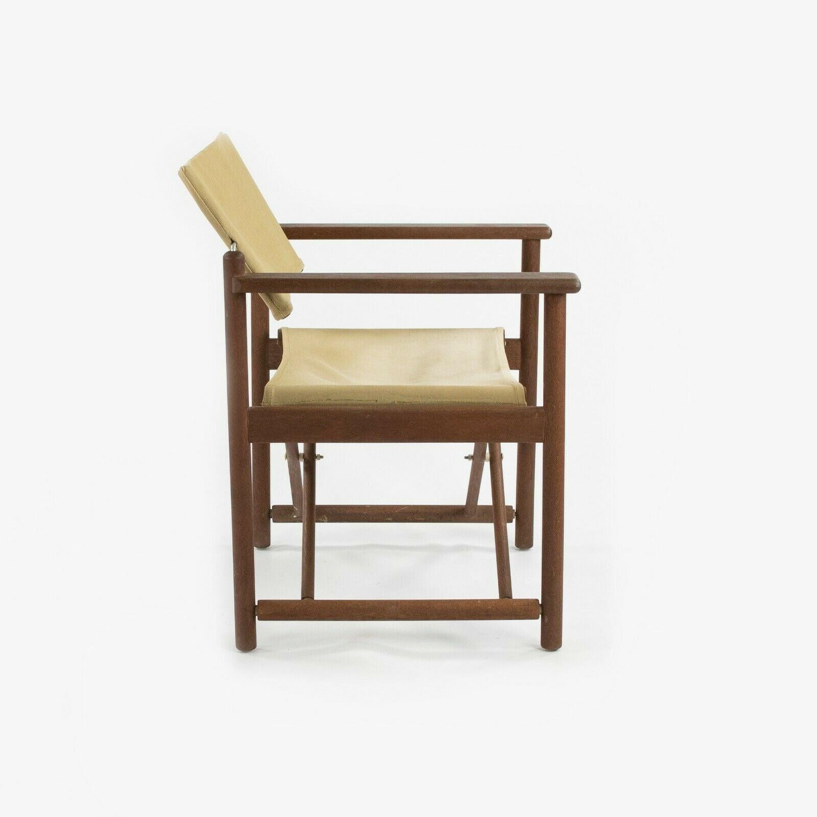 Listed for sale is a circa 1960s walnut and canvas campaign chair, which is reminiscent of Borge Mogensen and Mogens Koch designs from Denmark. The chair is in gorgeous original condition. The wooden components have held up nicely and canvas appears