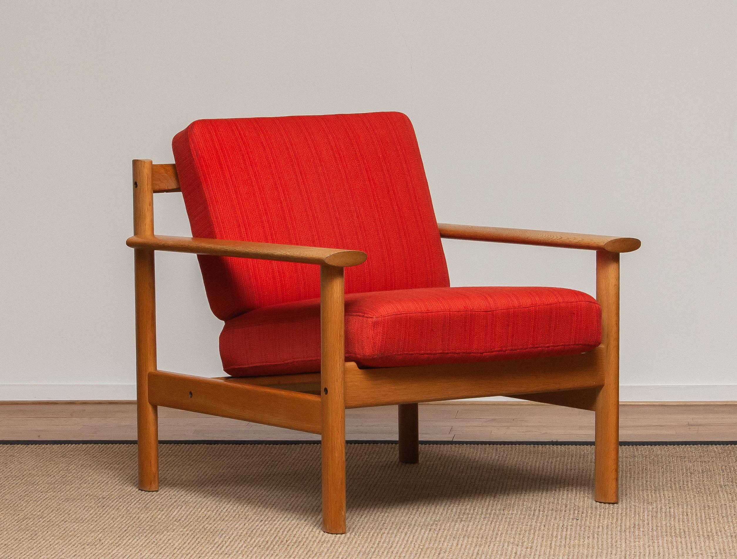 Firm Danish oak lounge easy chair in the manner of Poul Volther from the 1960s.
The cushions va a metal base with spring and still upholstered with the original fabric.
Overall condition is good.
Note that we have two similar chairs. See the last