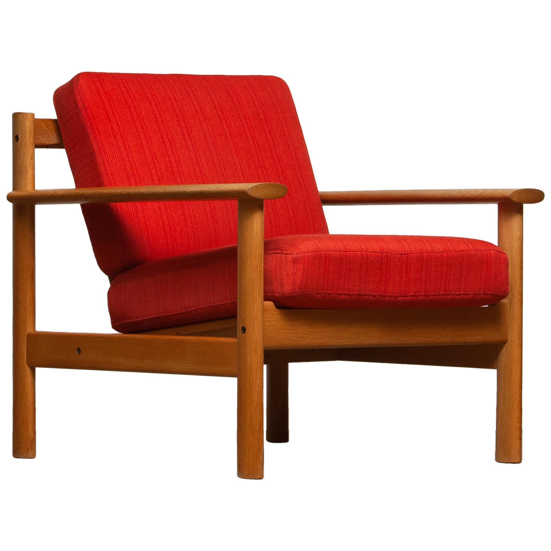 Firm Danish oak lounge easy chair in the manner of Poul Volther from the 1960s.
The cushions va a metal base with spring and still upholstered with the original fabric.
Overall condition is good.
Note that we have two similar chairs. See the last