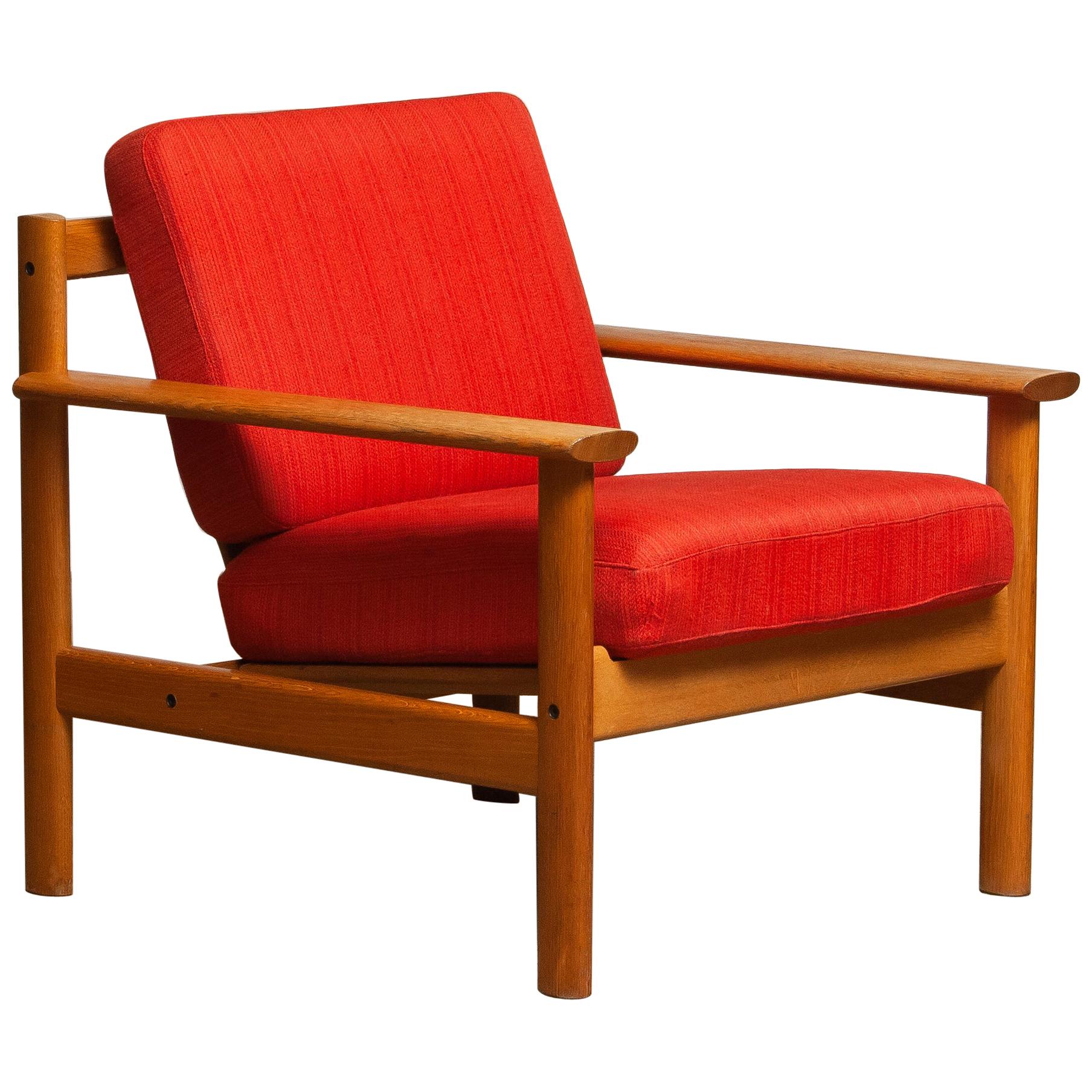 Firm Danish oak lounge easy chair in the manner of Poul Volther from the 1960s.
The cushions are a metal base with spring and still upholstered with the original fabric.
Overall condition is good.
Note that we have two similar chairs. See the