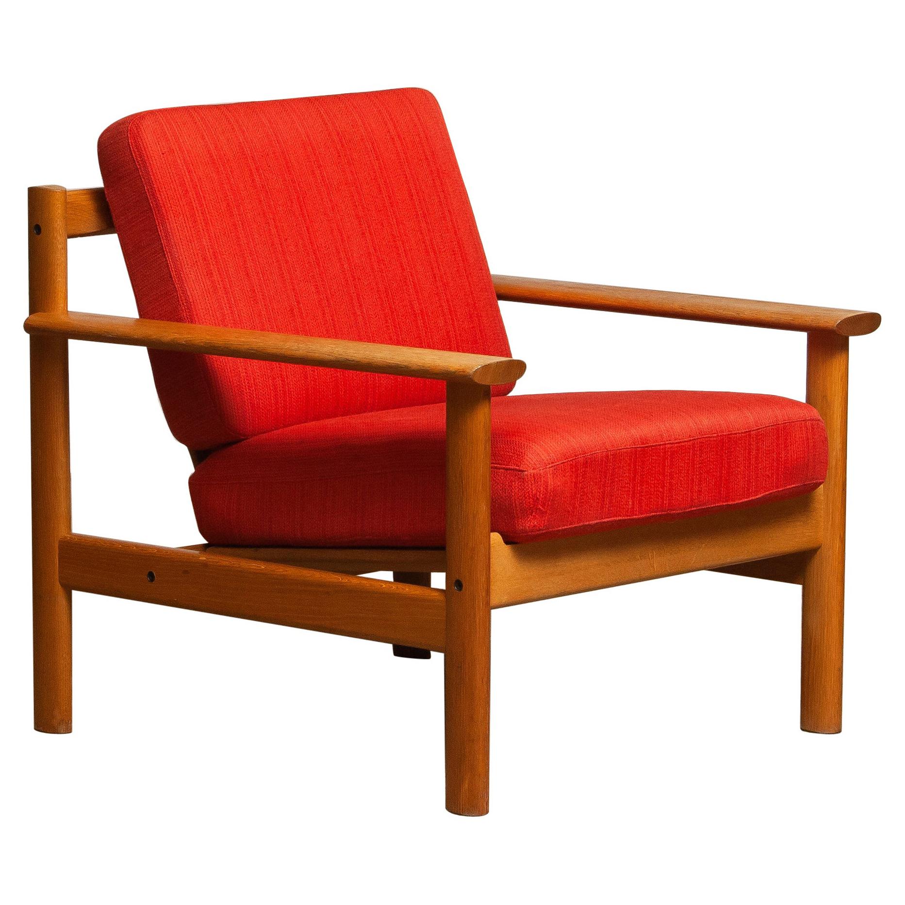 Firm Danish oak lounge easy chair in the manner of Poul Volther from the 1960s.
The cushions are a metal base with spring and still upholstered with the original fabric.
Overall condition is good.
Note that we have two similar chairs. See the