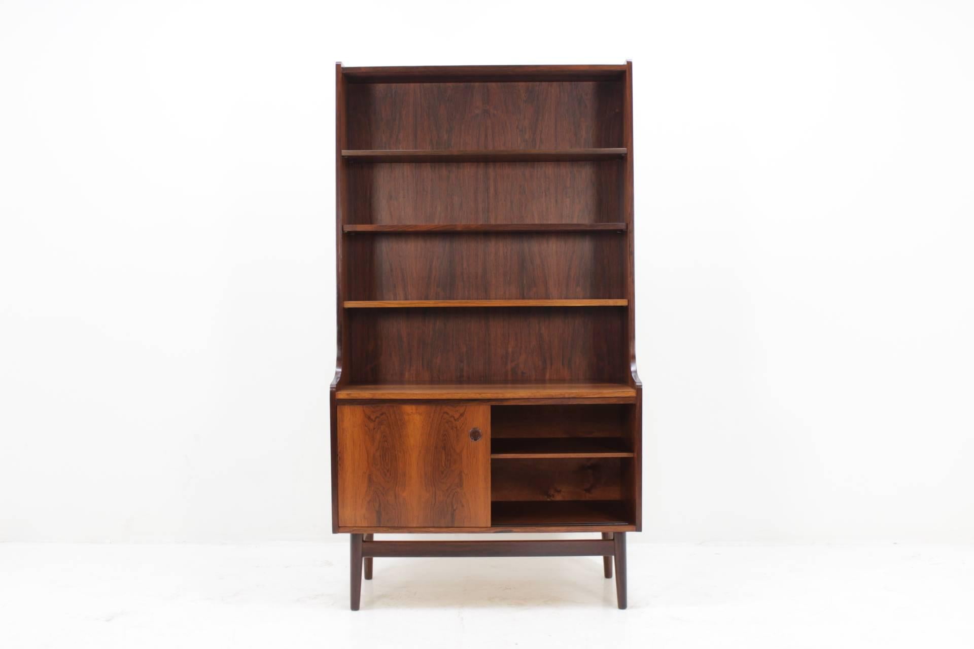 His cabinet features two sliding doors, and three adjustable shelves for books. The item was carefully restored.