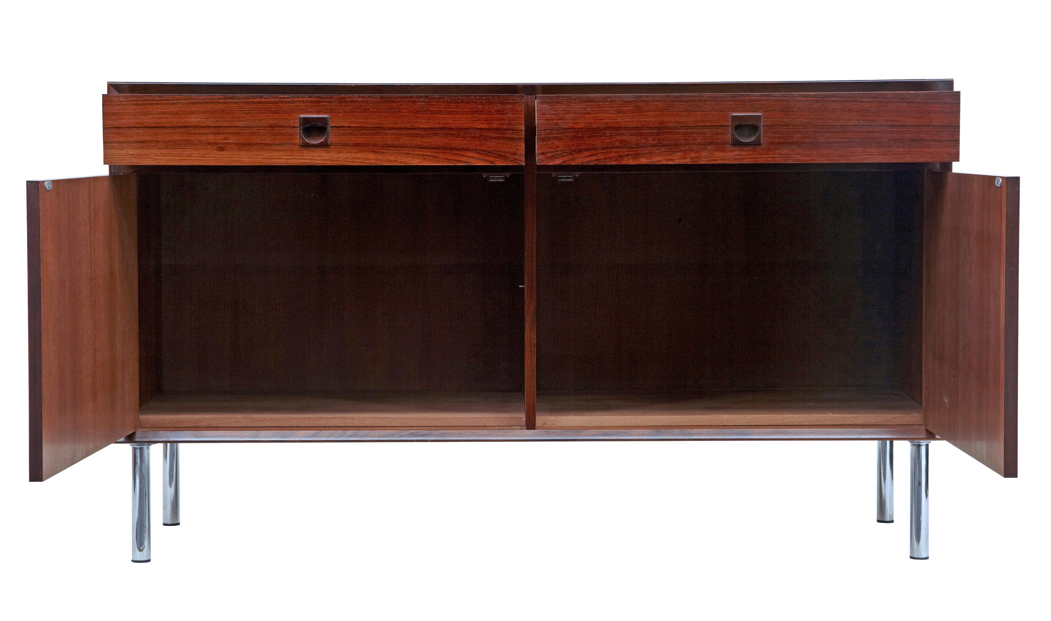 1960s Danish palisander buffet sideboard.

Good quality palisander veneers used on this sideboard. 2 drawers below the top surface with solid inset handles. Double door cabinet below opens to interior which would have housed 2 shelves. Standing on
