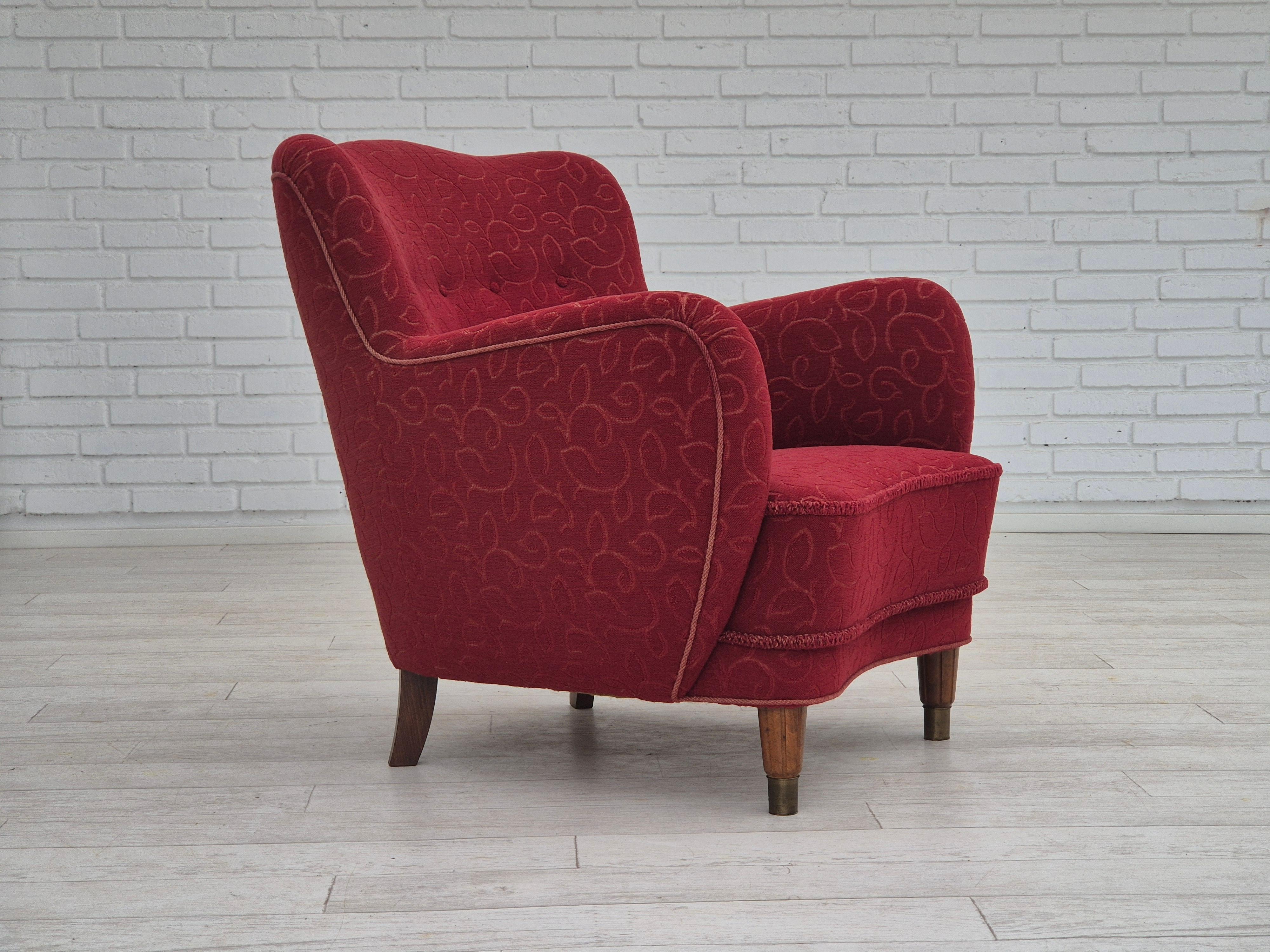 1960s, Danish design. Armchair in original very good condition: no smells and no stains. Original red cotton-wool furniture fabric. Beech legs with brass plugs, brass springs in the seat. Manufactured by Danish furniture manufacturer in about
