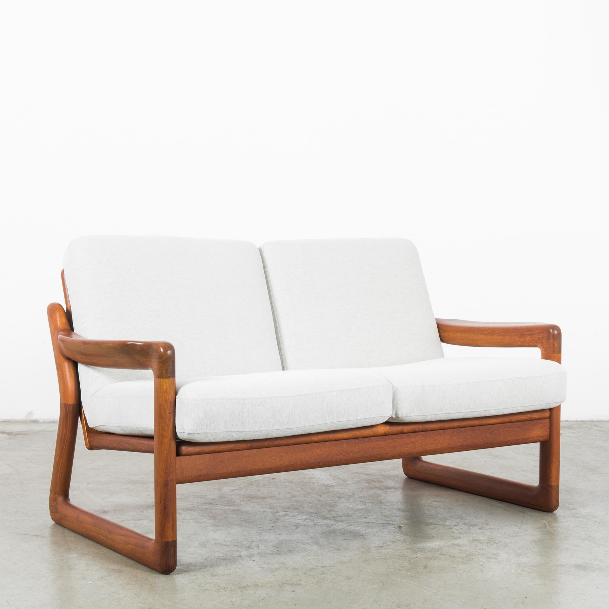 Embrace timeless comfort and mid-century charm with this 1960s Danish retro teak sofa. Crafted during a time when attention to detail and quality was paramount, this piece embodies the sleek, minimalist aesthetic that has become synonymous with
