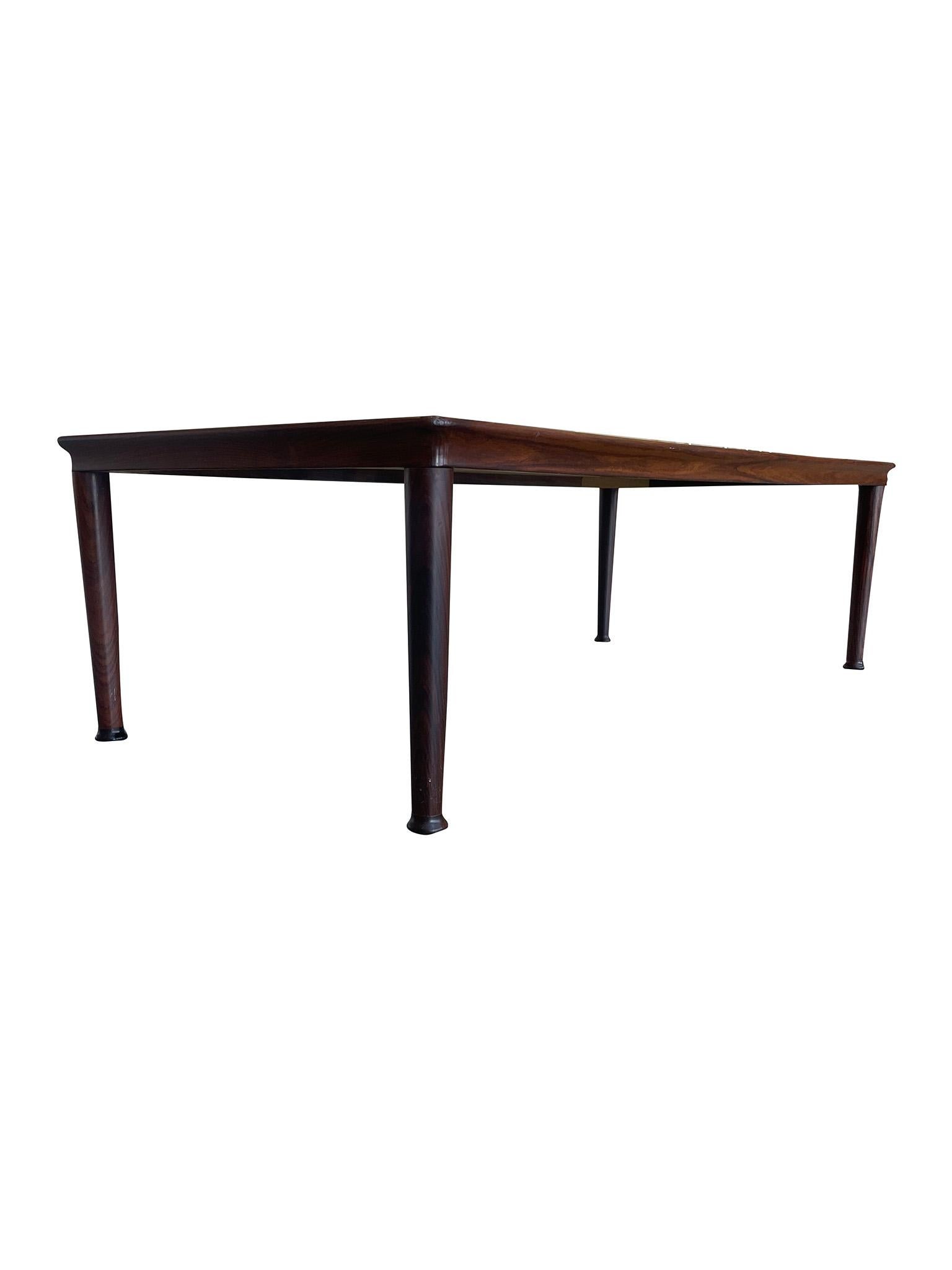 Versatile midcentury Danish Modern Coffee Table manufactured by Vejle Møbelfabrik Stole. Constructed in Rosewood, this coffee table is a lovely example of Danish craftsmanship and design ideals. Characterized by its minimal profile, emphasis on the