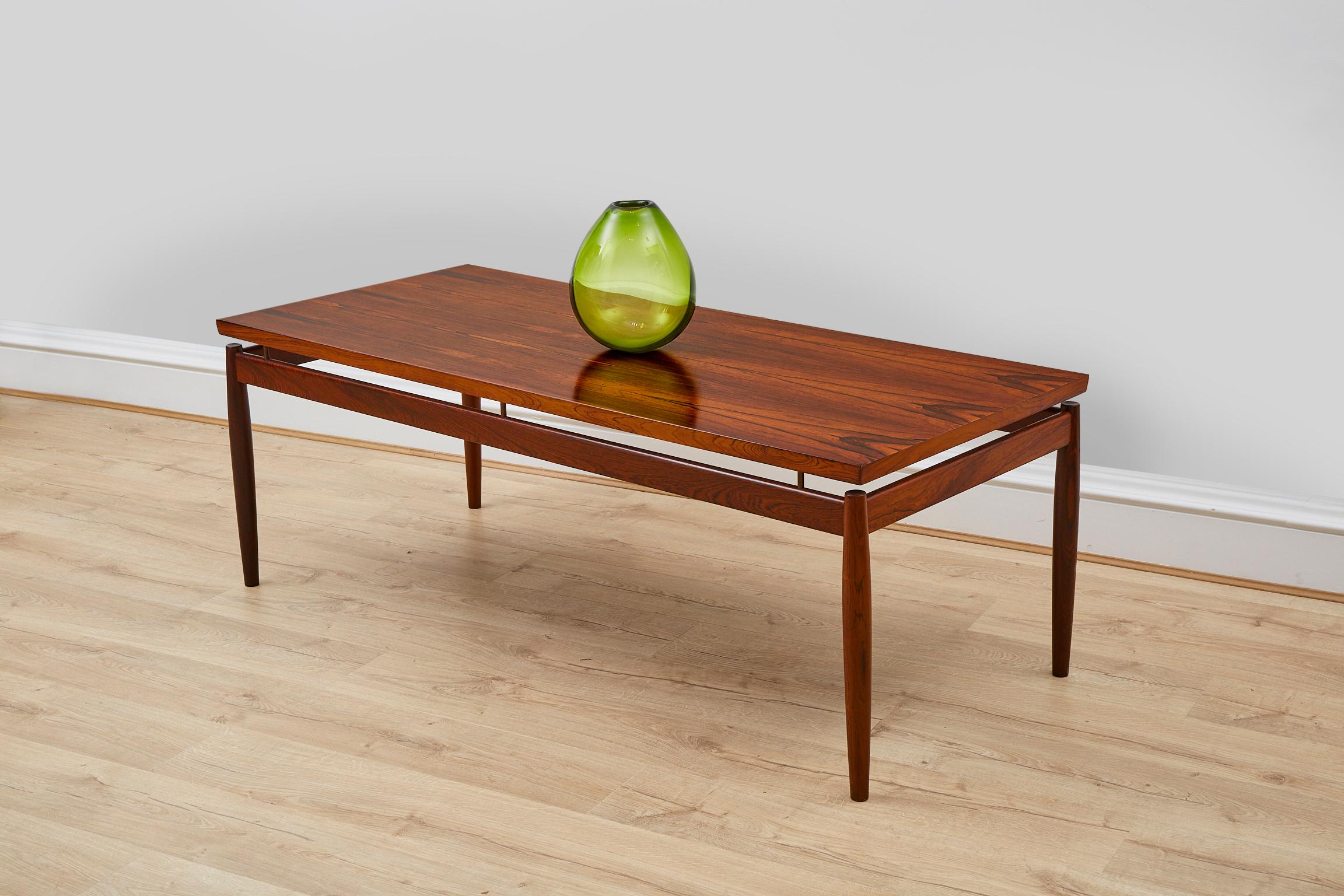 Beautiful and extremely rare rosewood coffee table designed by Grete Jalk for France & Son in the 1960s. 

About the Designer 
Grete Jalk

Recognized as an important Danish modernist designer—working at a time when women were a rarity in the design