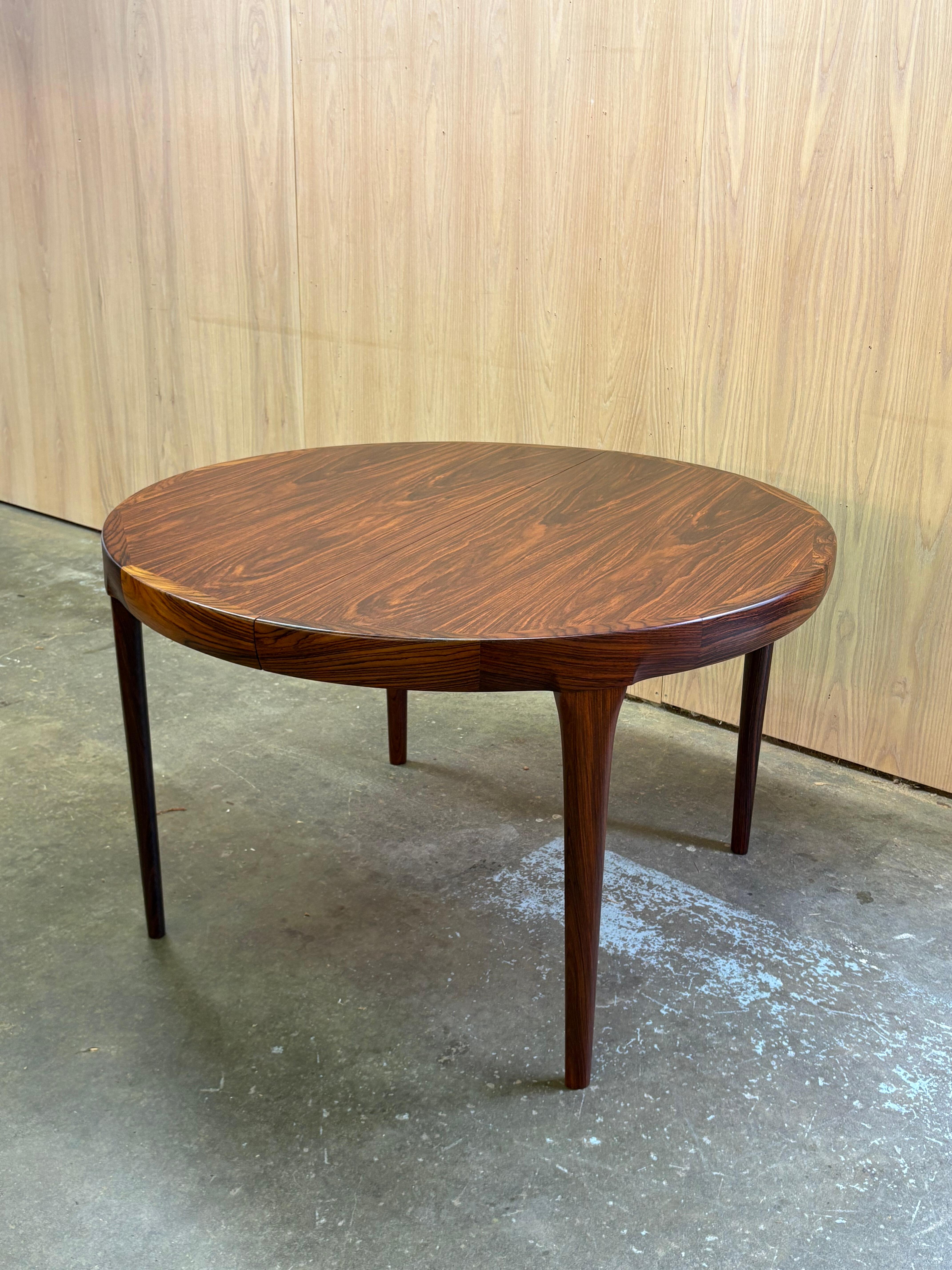 An exceptional example of Danish craftsmanship, this dining table by Kofod Larsen for Faarup Møbelfabrik showcases the refined elegance that defined mid-century design. The solid rosewood frame features sculpted legs that taper with precision,