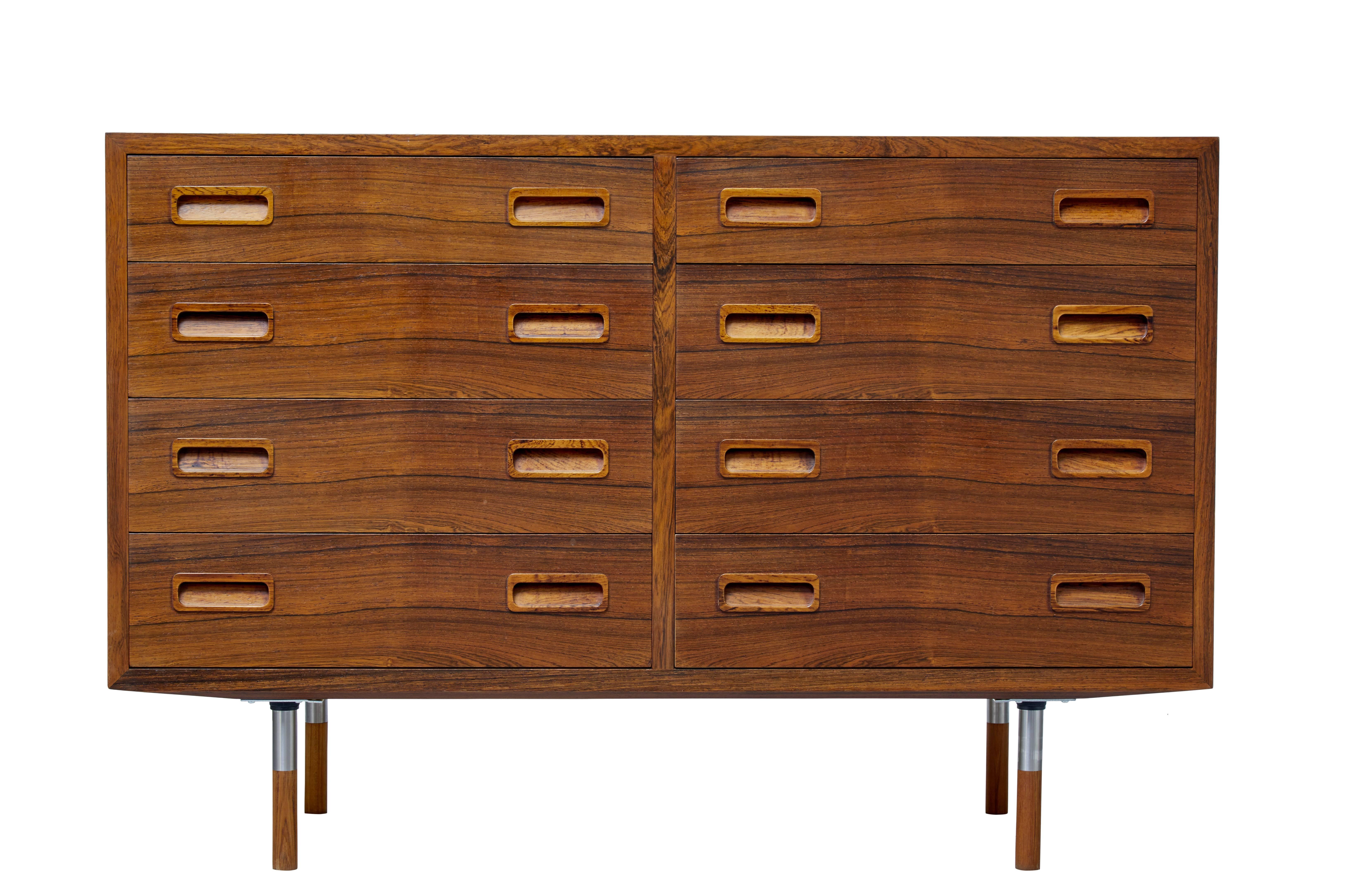 1960s Danish made rosewood chest of drawers.

Made from good quality rosewood veneers with inset rosewood handles.

Four graduating drawers on each side. Baize lined drawers which shows this was used as buffet.

Standing on chrome and wood