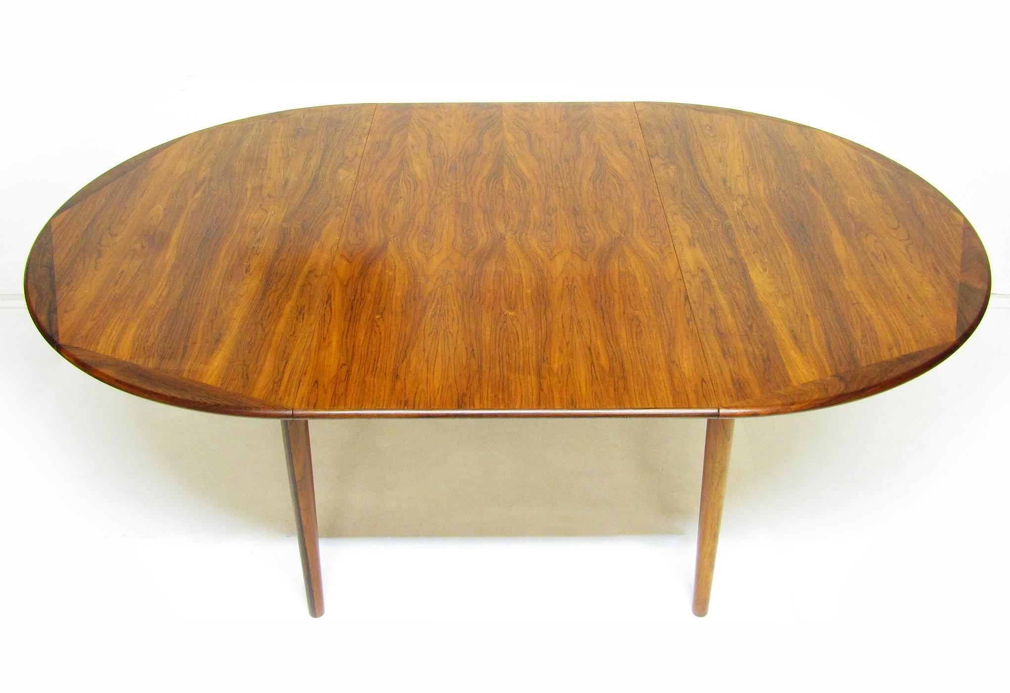 A beautiful 1960s Danish rosewood extending dining table by Georg Petersens.

The rosewood figuring is particularly fine, with a rich golden colour. Unlike many rosewood tables the leaf has approximately the same tone as the surrounding table.