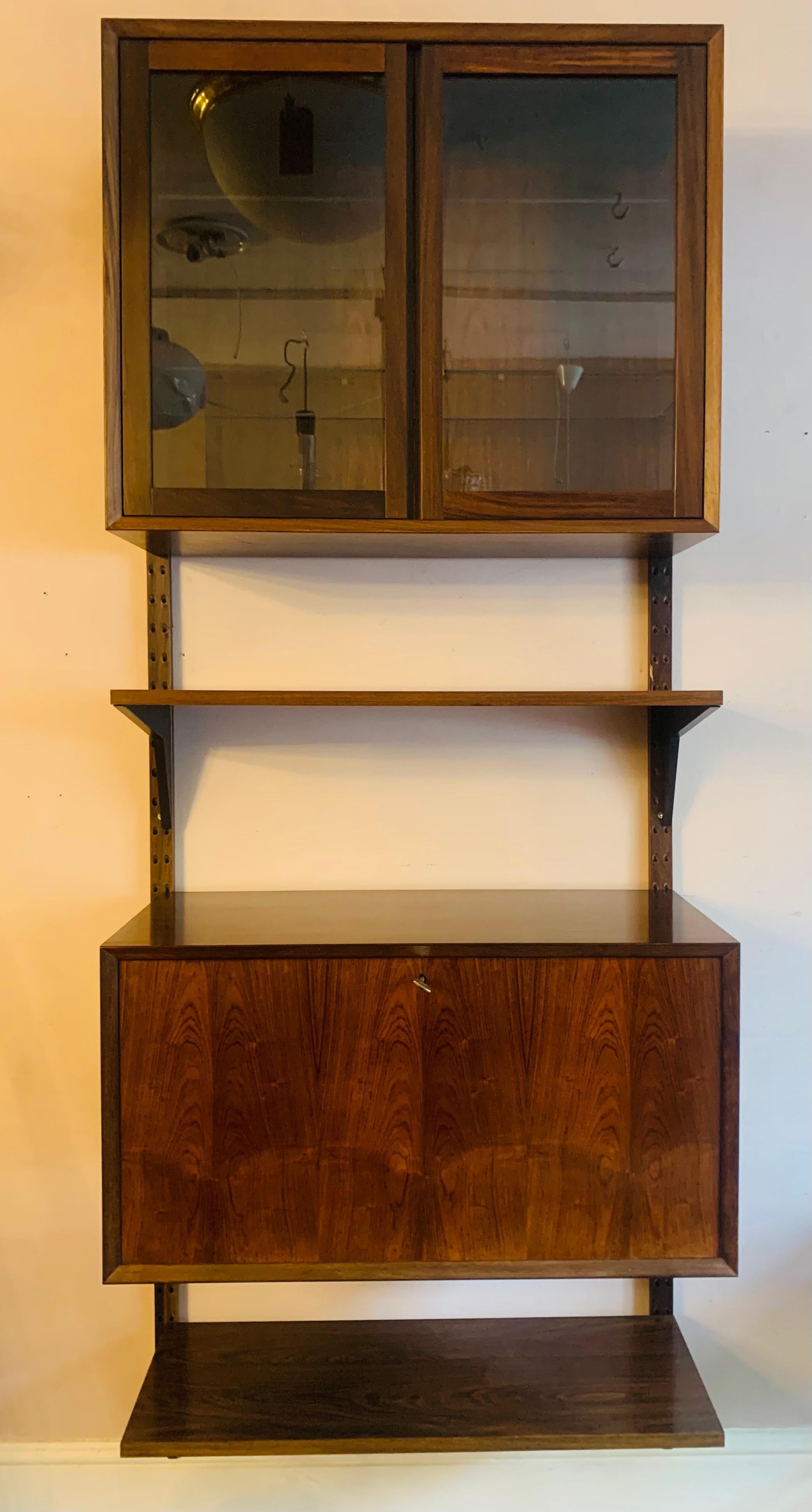 A well-sized, multi-functional Rosewood veneered, single wall-hung unit by Poul Cadovius for CADO. - Royal System Shelving Unit. 

The wall unit dates from the 1960s and is in very good condition considering its age. The unit consists of:

2 x