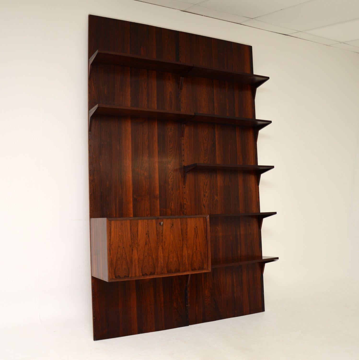 A stunning and rare vintage wood Royal Shelving system, designed by Poul Cadovius. This was made in Denmark, it dates from the 1960-70’s.

It is of absolutely superb quality, and is such a clever design. There are two large flat wood panels that