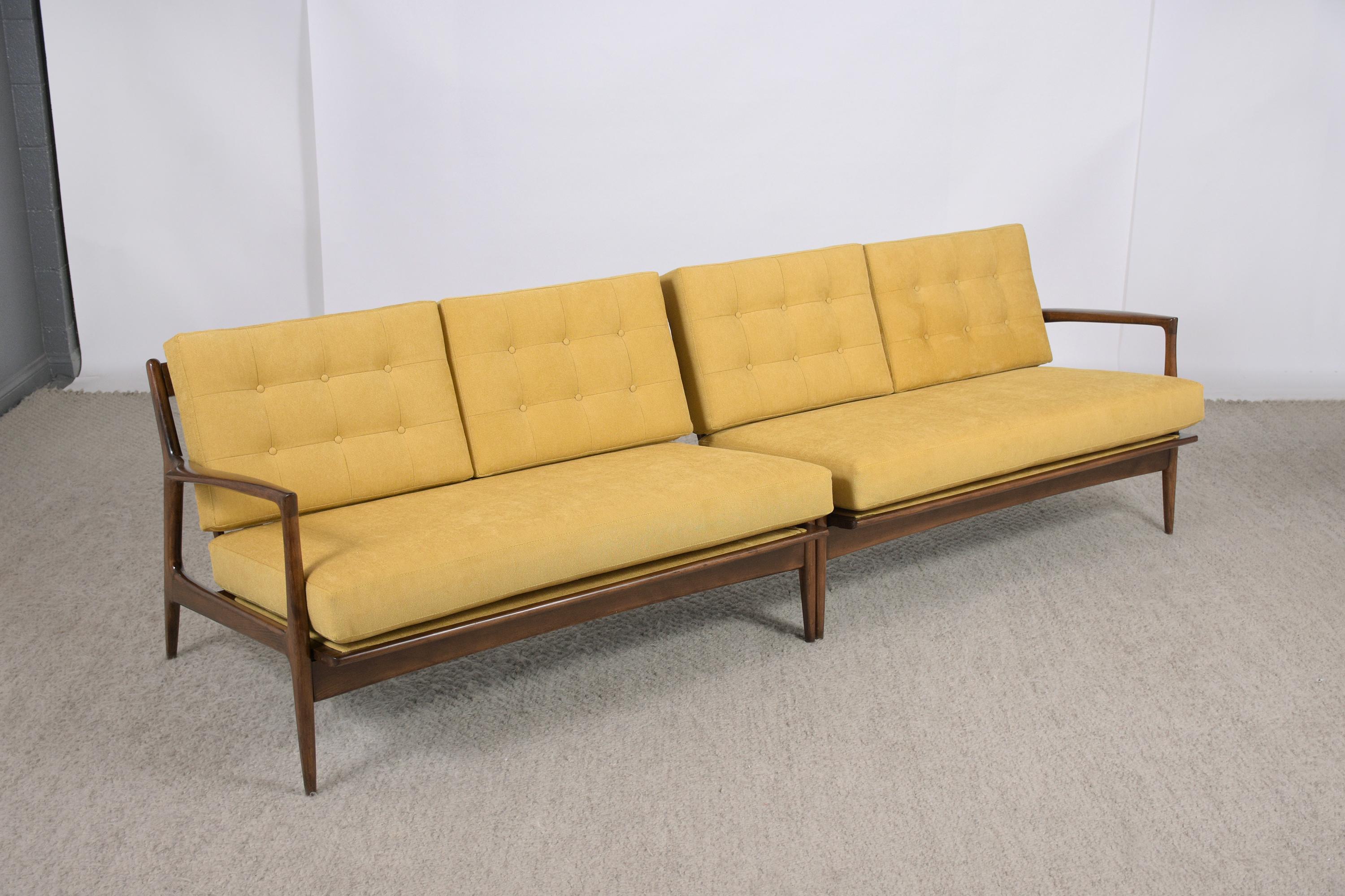 Immerse yourself in the classic charm of the 1960s with our mid-century modern Danish sectional sofa, a masterpiece of Scandinavian design handcrafted from teak wood. This vintage sofa has been meticulously restored by our team of skilled craftsmen,
