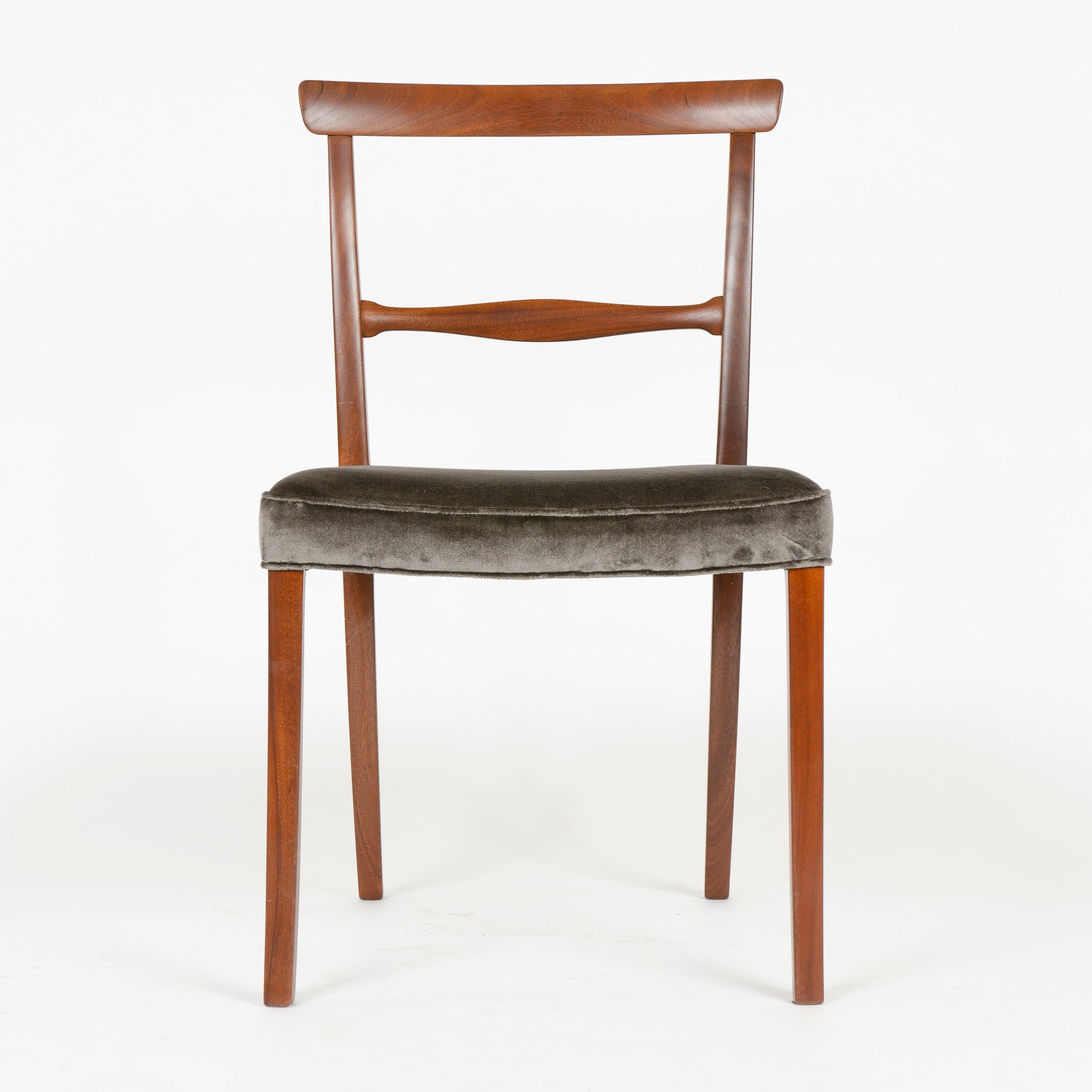 Designed in 1962, this expertly crafted dining chair by Ole Wanscher was built in the cabinet shop of A. J. Iversen of Brazilian rosewood in the 1960s. A graceful, minimal design consisting of only essential elements; a slight crest rail which