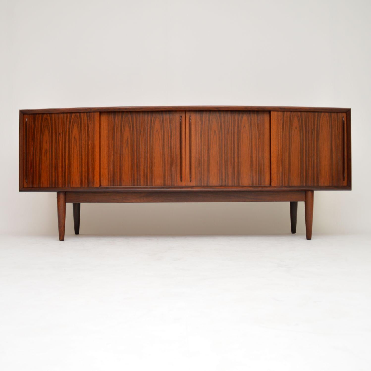 A superb and very rare vintage Danish sideboard, this was designed by Arne Vodder, it was made by HP Hansen in the 1960s. The quality is amazing, it’s unusual to see a bowed front like this. There is lots of storage space including felt lined tray