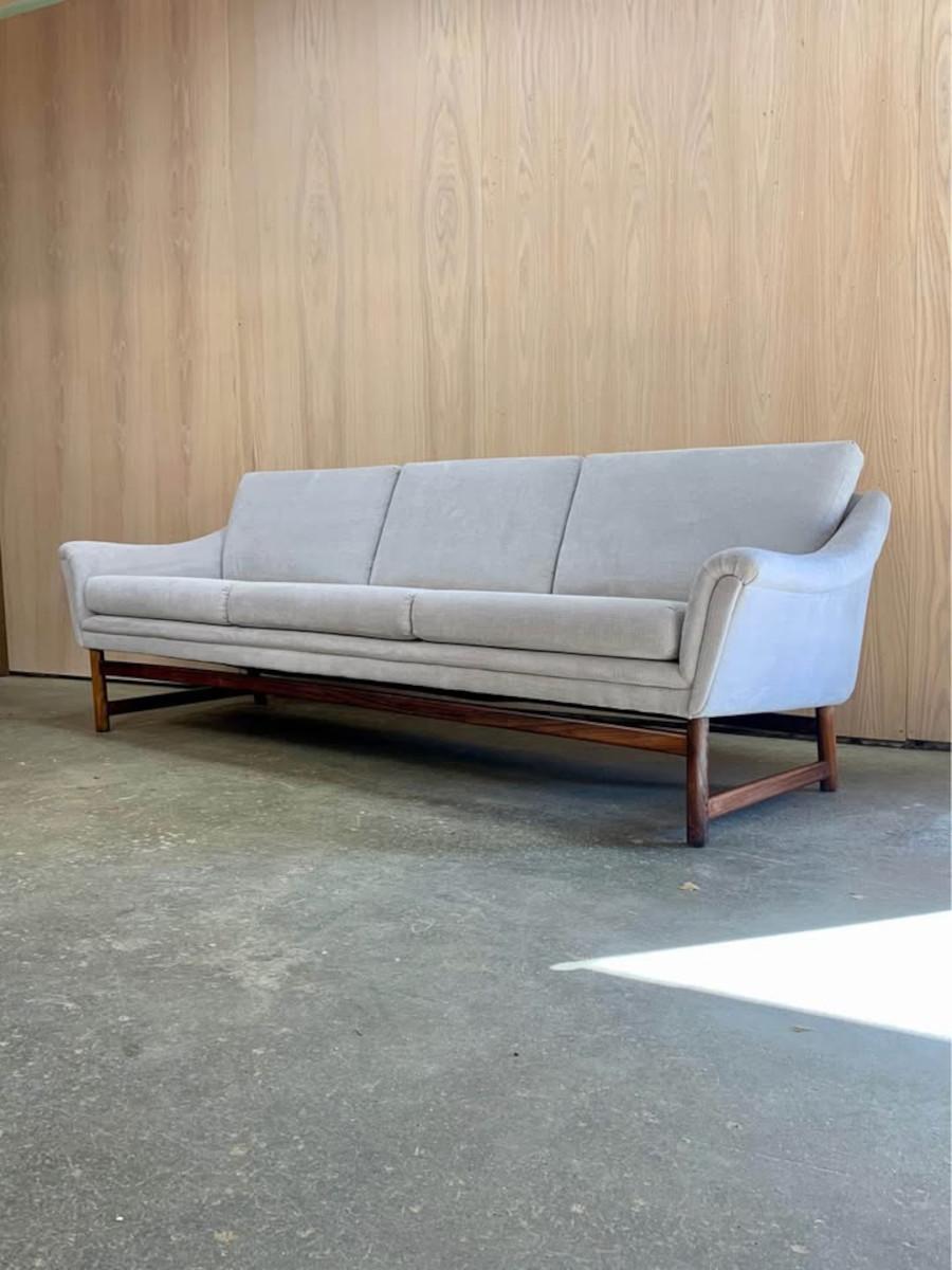 New to our collection, this stunning Danish sofa from the 1960s is a true standout. It features a solid Brazilian rosewood base, elegantly contrasted by a light, neutral-toned fabric. Freshly restored by our team, it’s as comfortable as it is