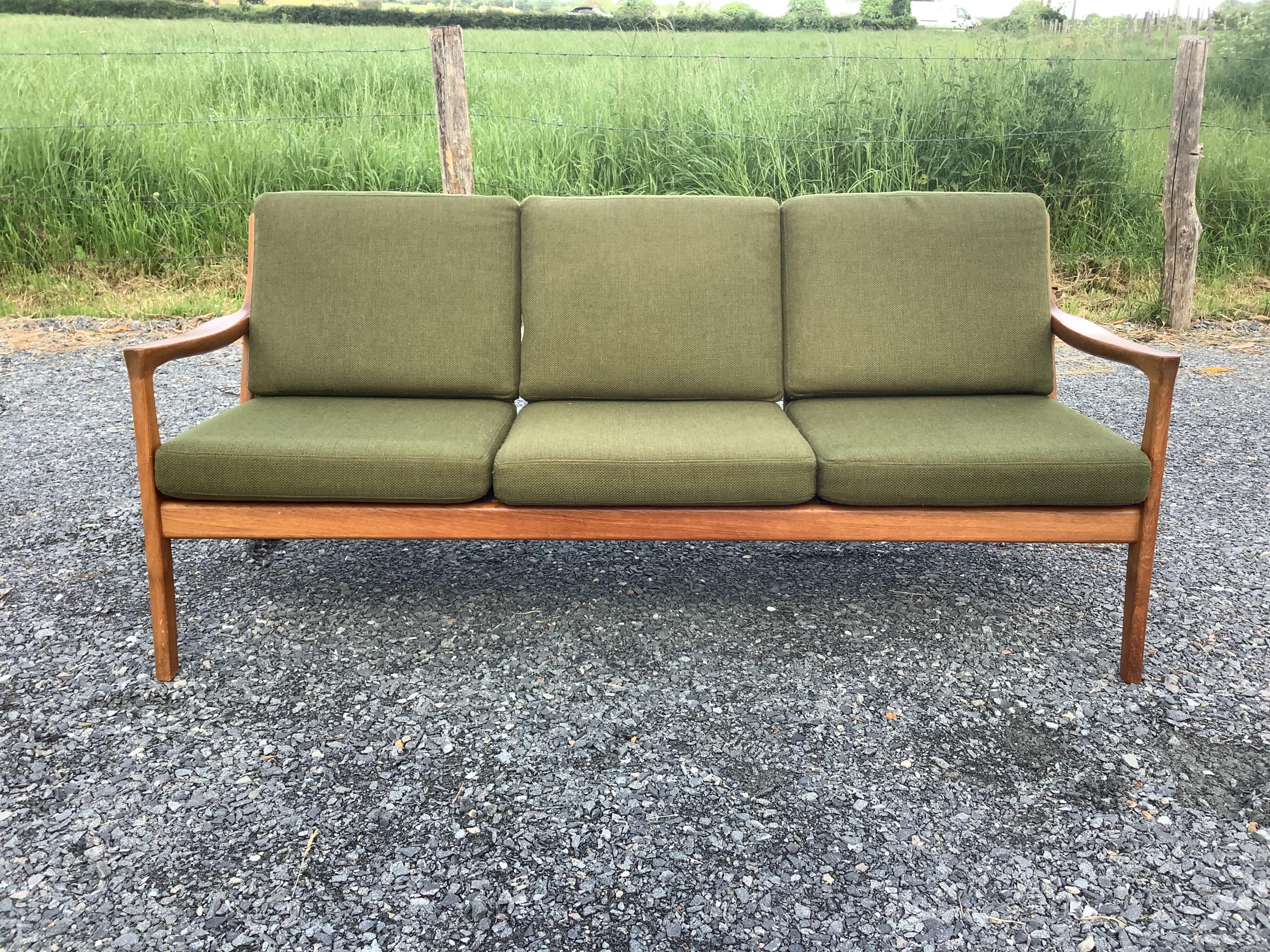 1960’s stunning solid teak sofa in the style of Ole Wanscher wonderfully crafted frame with an 
Amazing organic shape. With six upholstered green 
Cushions.