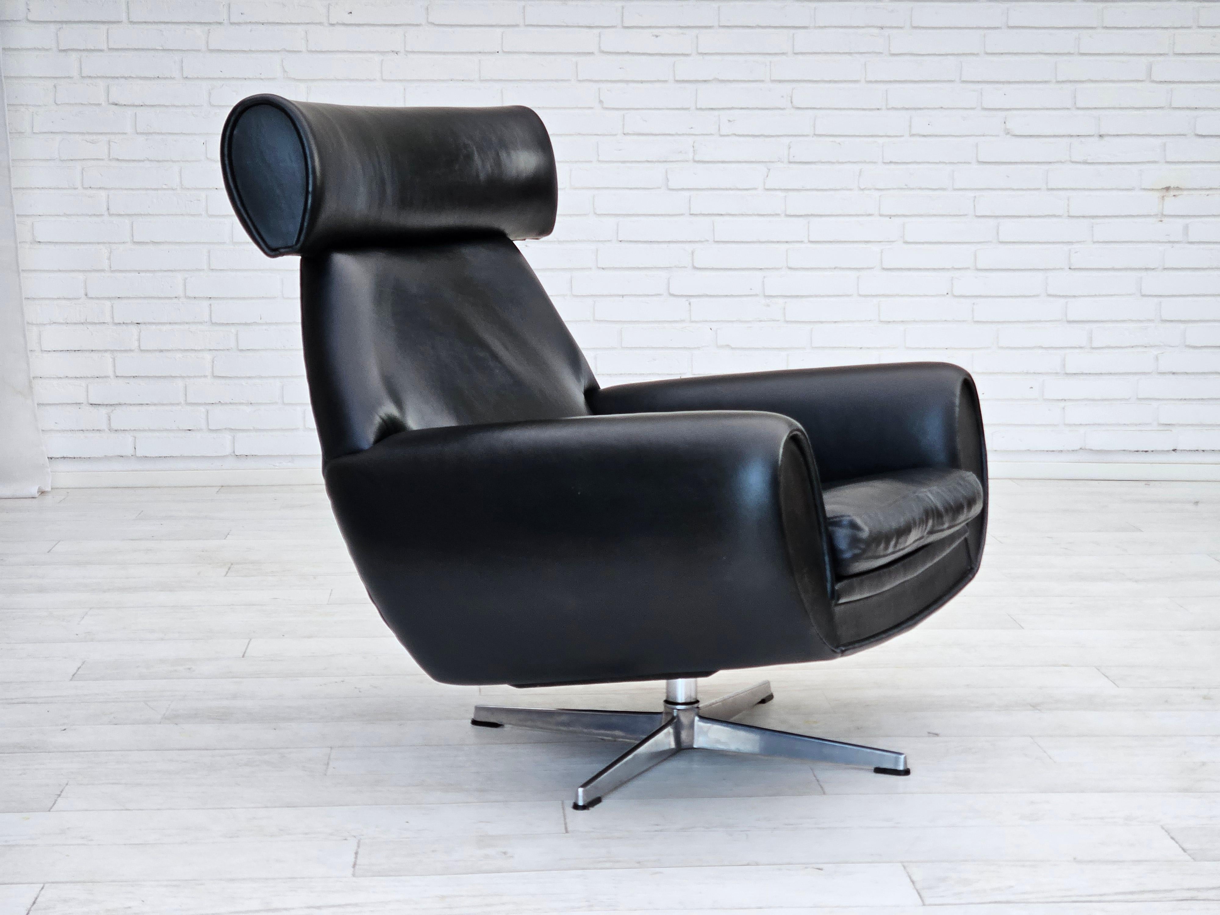 1960s, Danish swivel chair in original very good condition: no smells and no stains. The chair used not too much from the 1960s. Original black leather, cast aluminum base. Manufactured by Danish furniture manufacturer in about 1960-65s.