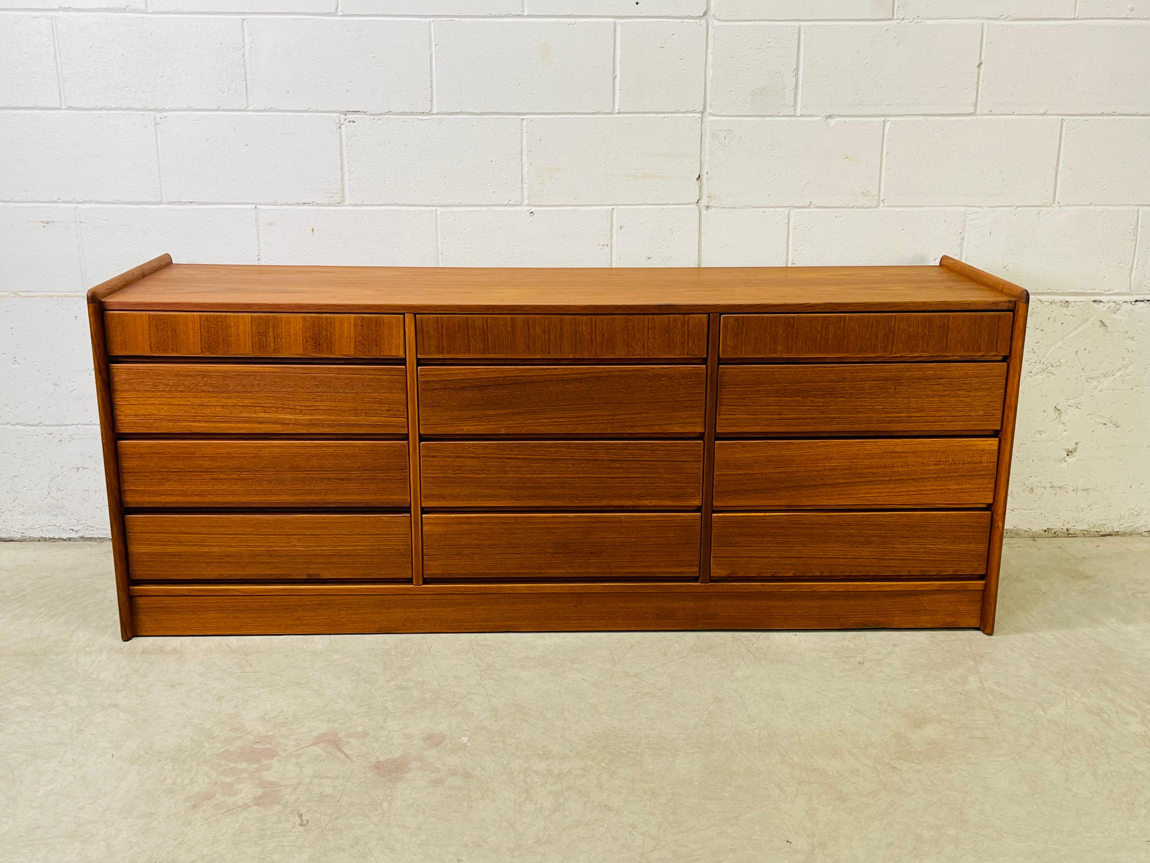 Vintage 1960s Danish teak long and low dresser with 12 drawers. The dresser drawers range in height from 3.25”H to 5.25”H. The interior of the dresser is a light birch wood. No marks.