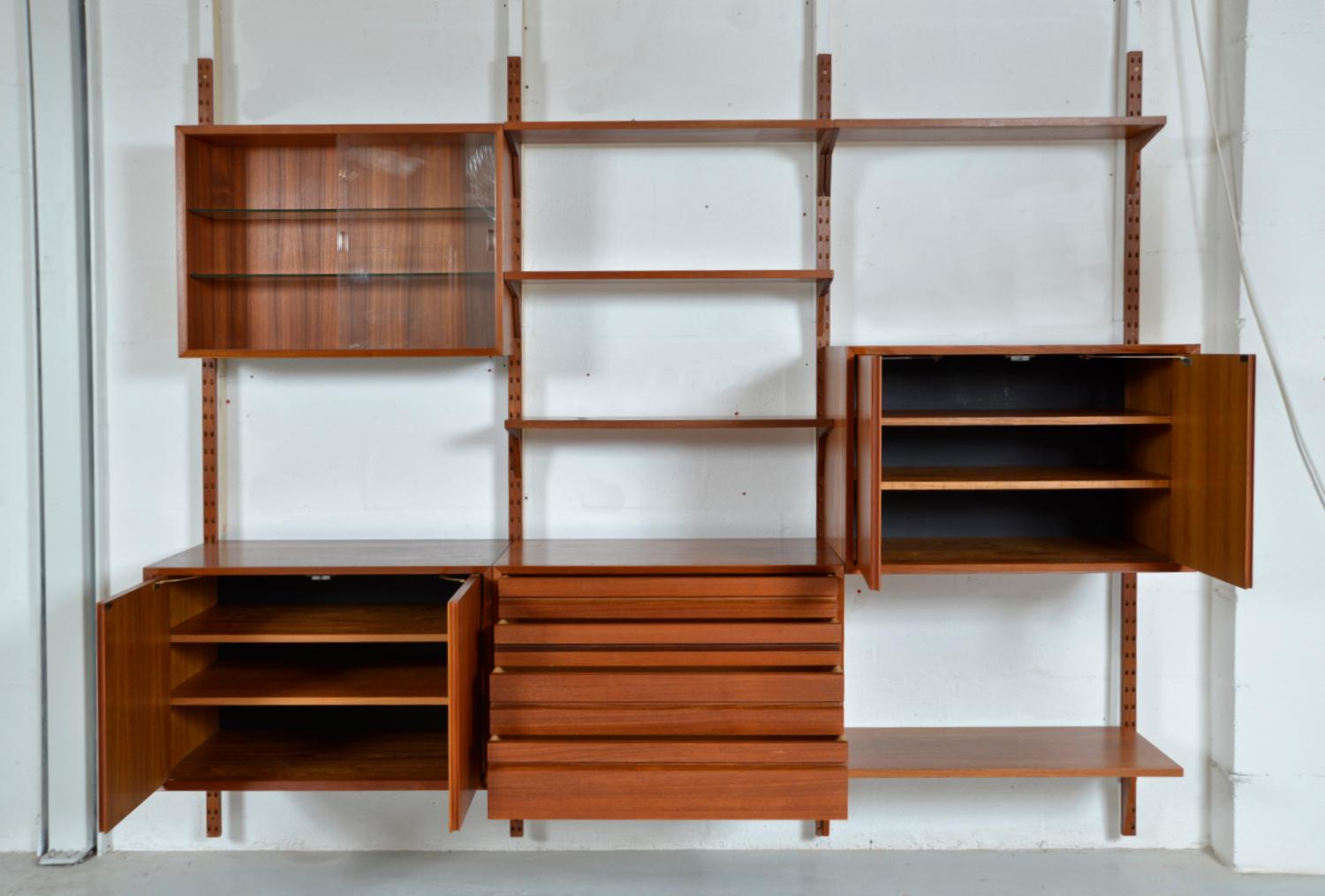 A stunning 1960s three-bay Danish teak CADO shelving system designed by Paul Cadovius consisting of 13 pieces, including the uprights. These designer shelves are fully modular, allowing an infinite number of combinations and is easily assembled to