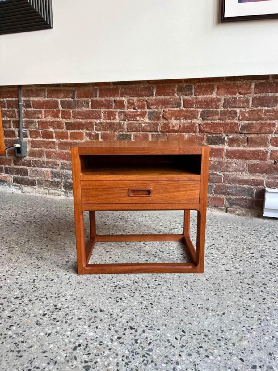 Fresh to the showroom is this 1960's Danish Aksel Kjersgaard nightstand or side table. Crafted from teak wood, its curves and lines echo the essence of Scandinavian design. With a single drawer and small shelf, it stands ready to cradle your