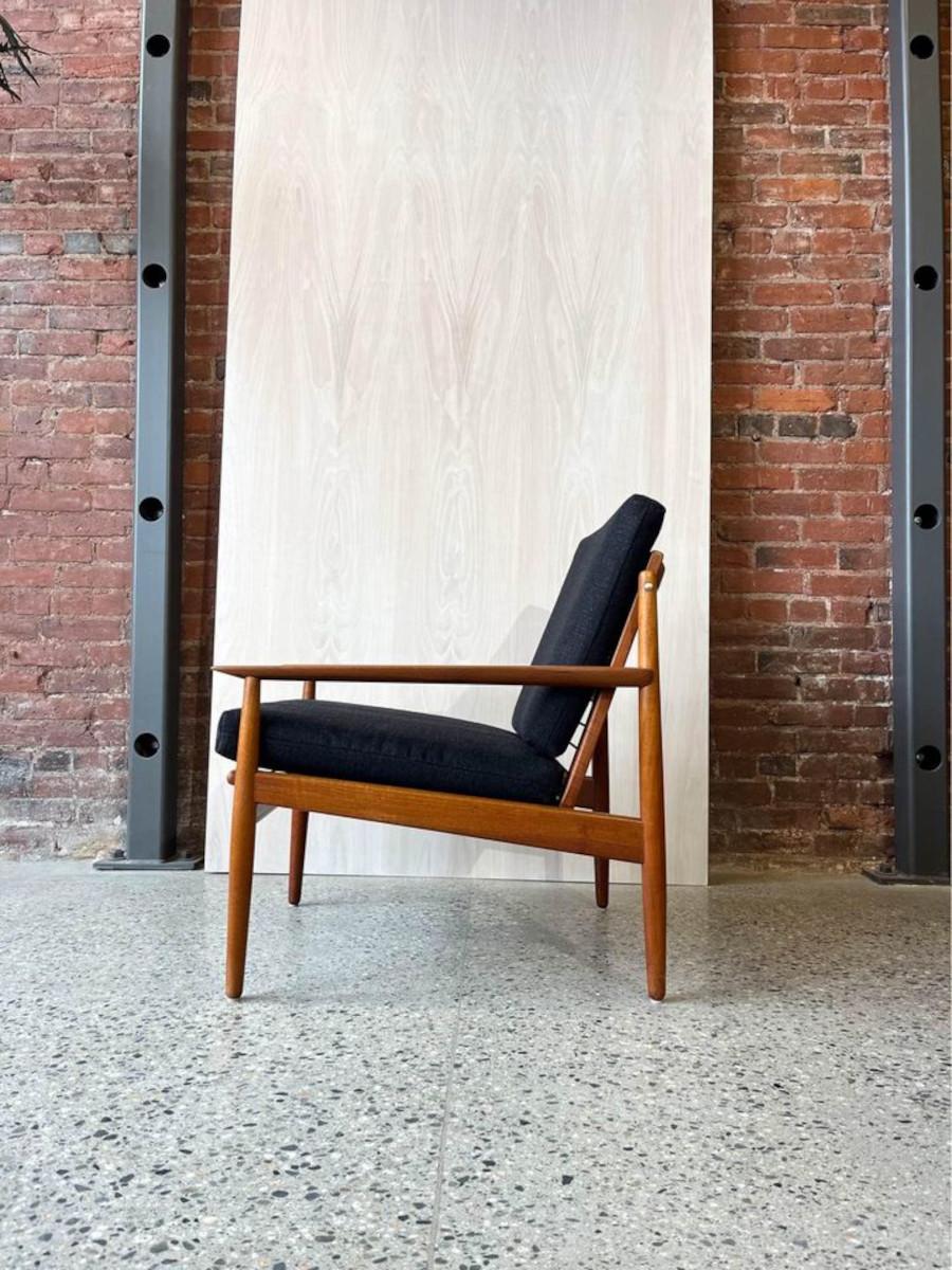 Introducing this captivating 1960s Danish teak lounge chair, a true embodiment of mid-century modern design. With its distinctive exaggerated angles and sleek lines, this chair commands attention with its bold yet elegant presence. Meticulously
