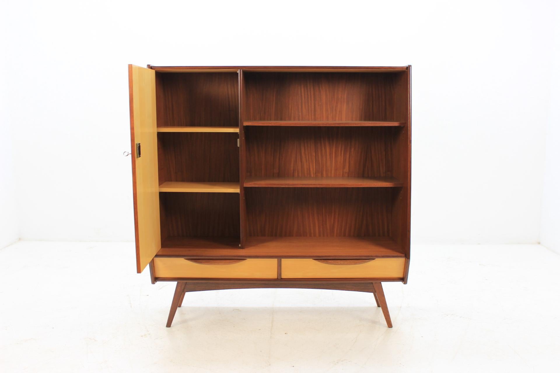 This cabinet features two shelves, one-door compartment with two inner shelves and two drawers. This item was carefully restored.