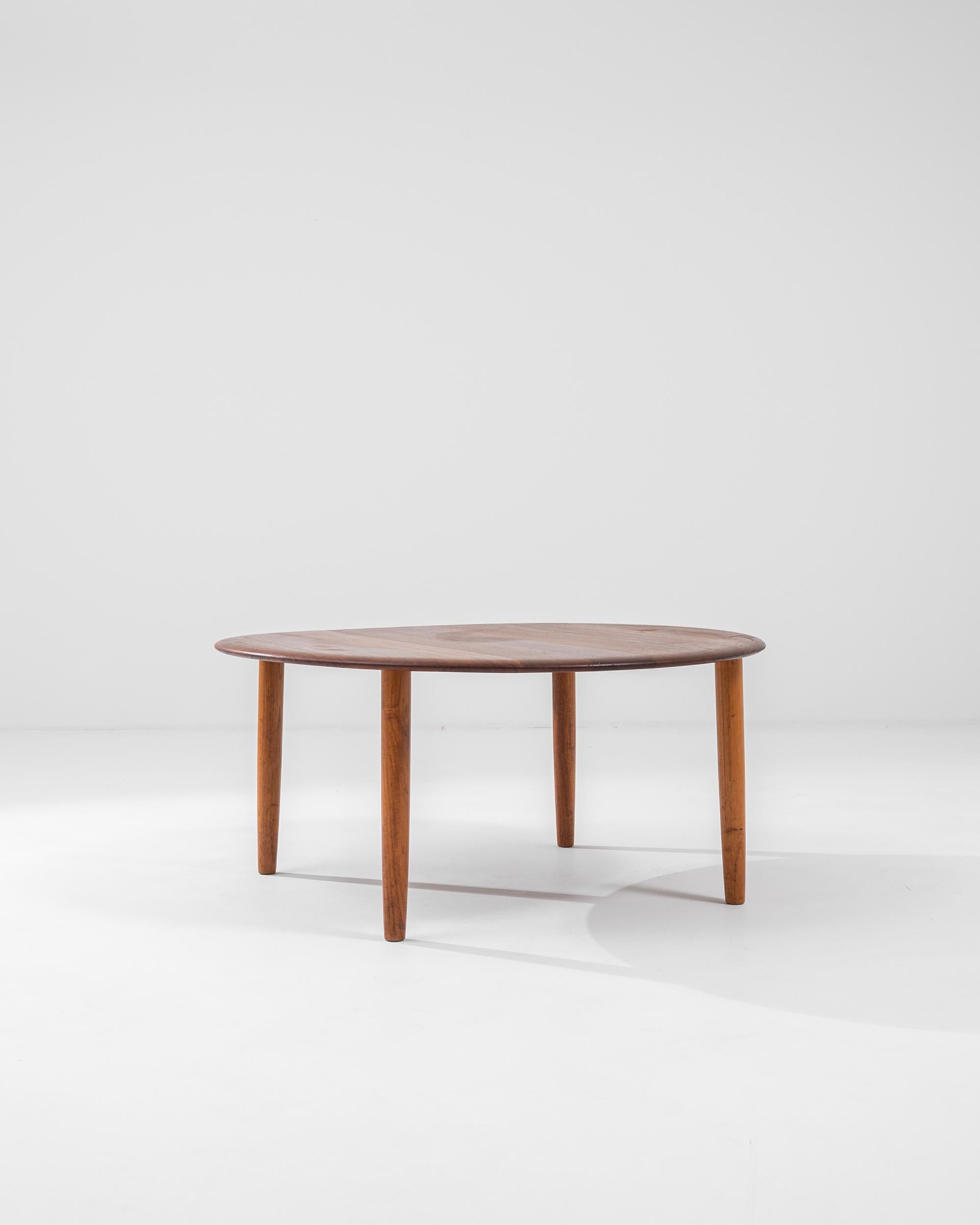 A wooden coffee table from 1960s Denmark. Constructed from solid teak, a staple of mid-century Danish design, this elegantly minimal table radiates a handsome cheer. Gently curved edges and bright wood tones both exude a homely glow and also