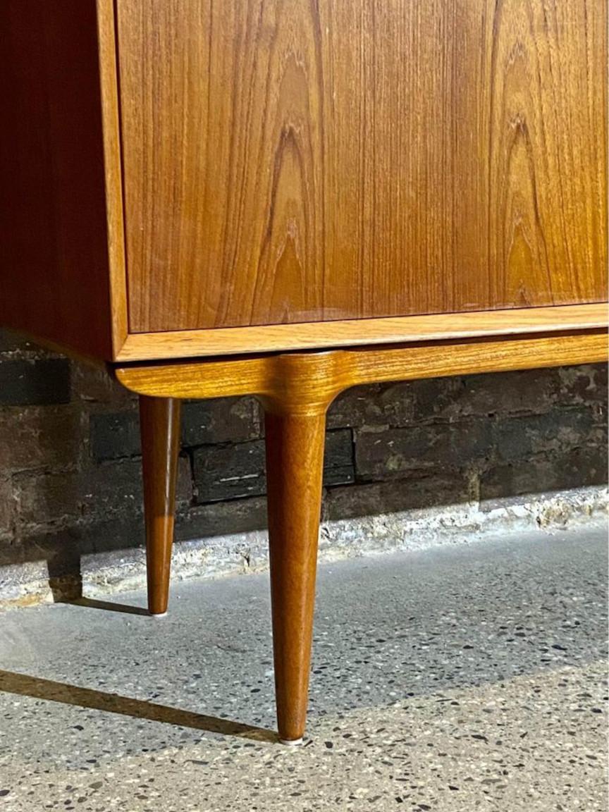 Excited to offer this large scale Danish teak storage cabinet by Omann Jun circa 1960s. It features an exquisite leg structure, a large central storage cabinet with adjustable shelving, and a bank of solid beech drawers. Freshly restored by our