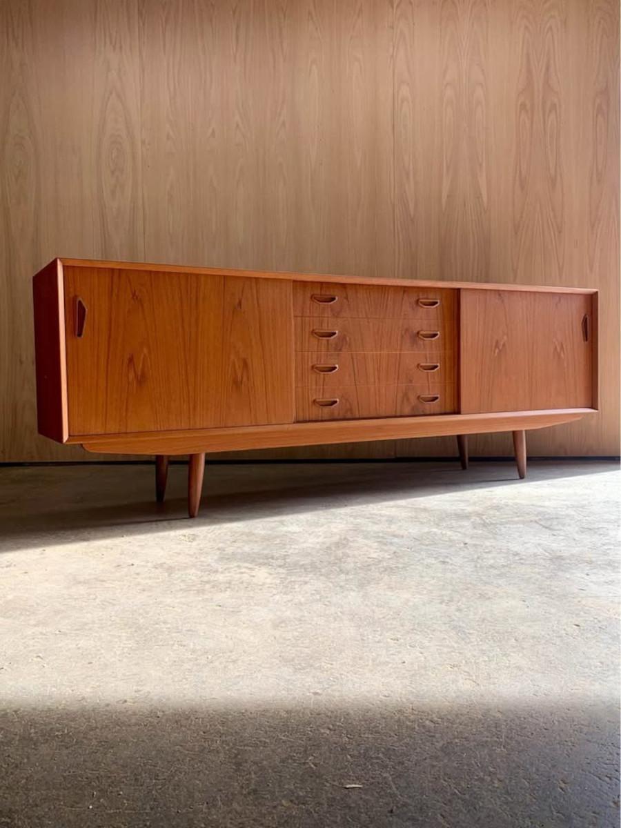 Fresh from restoration, we’re excited to present a stunning teak credenza crafted in Denmark during the 1960s. Notable features include charming splayed legs, solid wood dovetailed drawer fronts, as well as a fully finished back. Freshly restored by