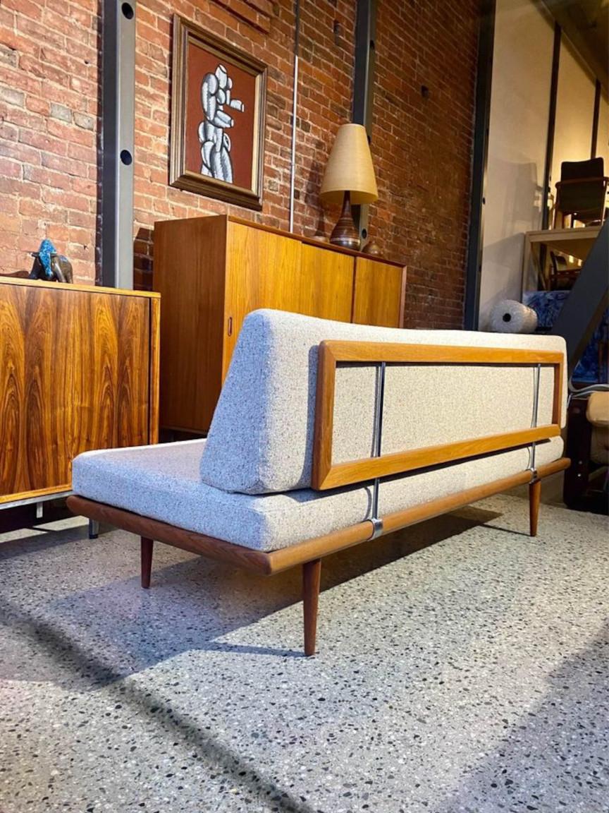 We are pleased to offer a classic Danish modern sofa signed by Peter Hvidt for France & Son circa 1960s. This beautiful piece works nicely as a compact sofa and also as a spare single bed with the backrest removed. The entire piece is freshly