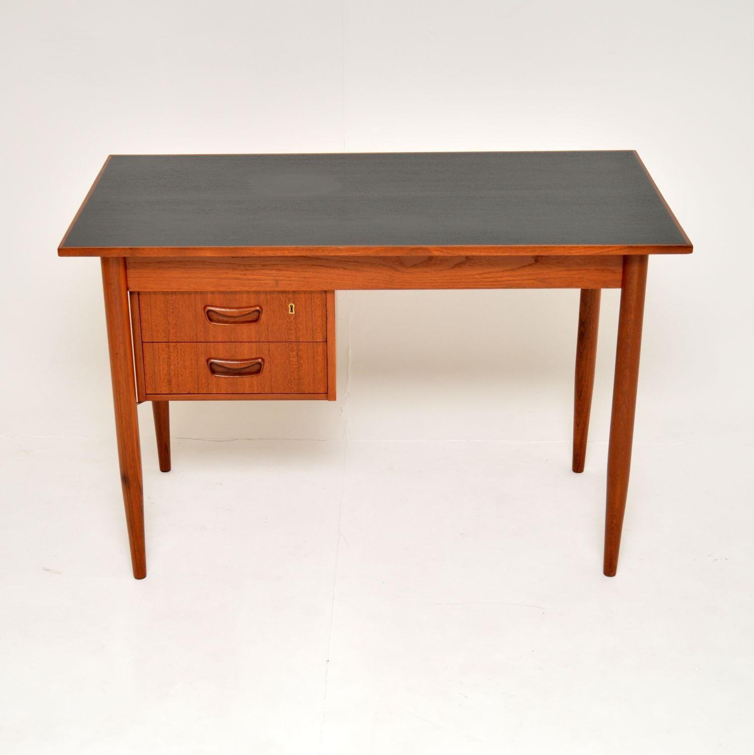 A sleek and stylish Danish vintage teak desk. This was designed by Gunnar Nielsen for Tibergaard, it dates from the 1960’s.

It is of useful proportions and is of excellent quality. The top is ebonised, the rest of the desk is finished in