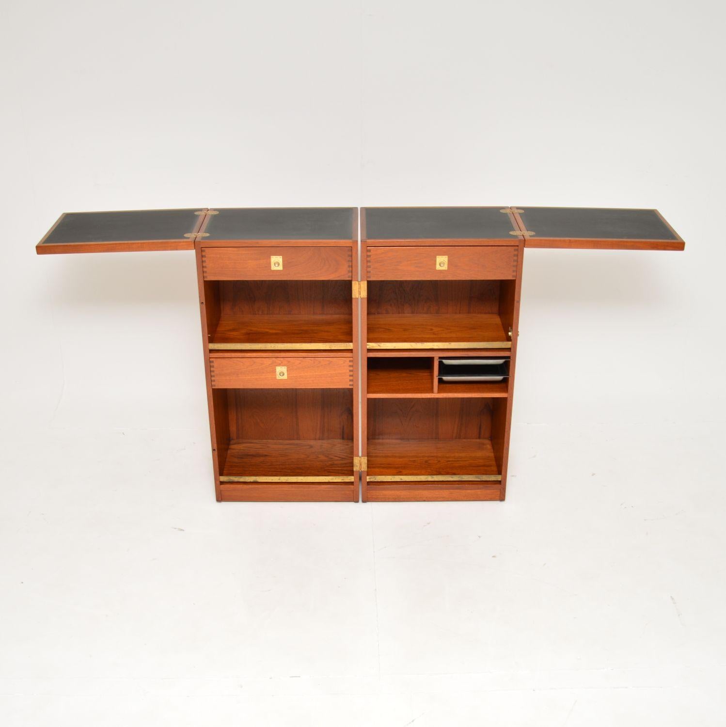 A stylish and extremely well made vintage Danish teak drinks bar. This was designed by Reno Wahl Iversen, it was made in Denmark by Dyrlund around the 1960’s.

The design is very clever, it stands closed as a compact unit that can be opened out as