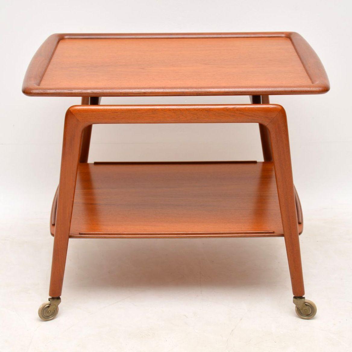 A stunning and rare vintage Danish drinks trolley in teak, this was designed by Arne Hovmand-Olsen, it was made by Mogens Kold. It is super quality, has a beautiful and striking design, the condition is superb throughout. We have had this stripped