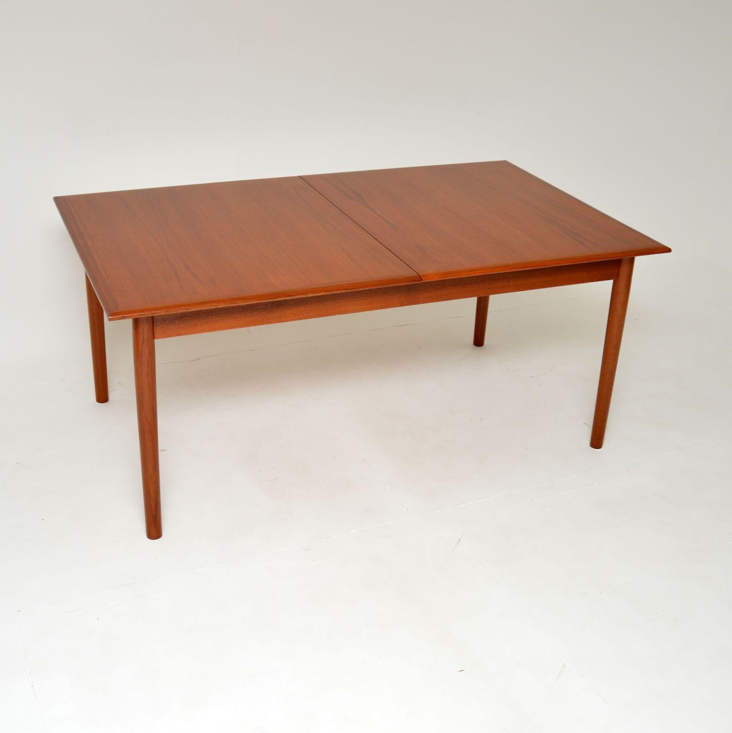 A superb vintage Danish extending dining table in teak. This was made in Denmark by Bernhard Pedersen, it dates from the 1960’s.

It has three additional leaves to extend the dining area to comfortably seat twelve, and can even seat up to