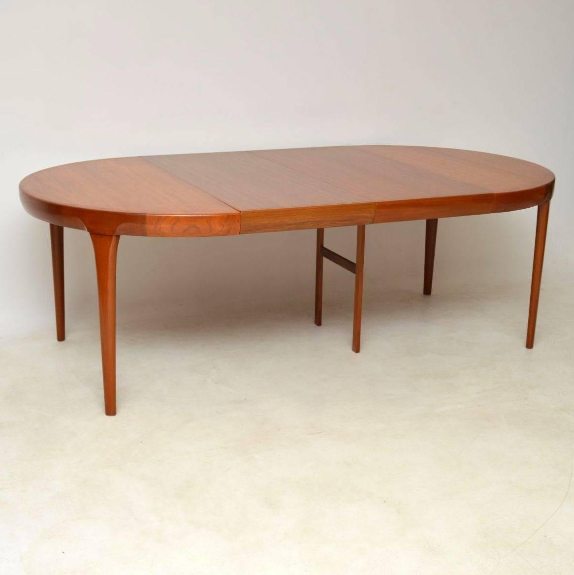 A stunning vintage Danish teak dining table of the highest quality, this was designed by the great IB Kofod Larsen. It dates from the 1960s, we have had this stripped and re-polished to a very high standard, the condition is superb throughout. This