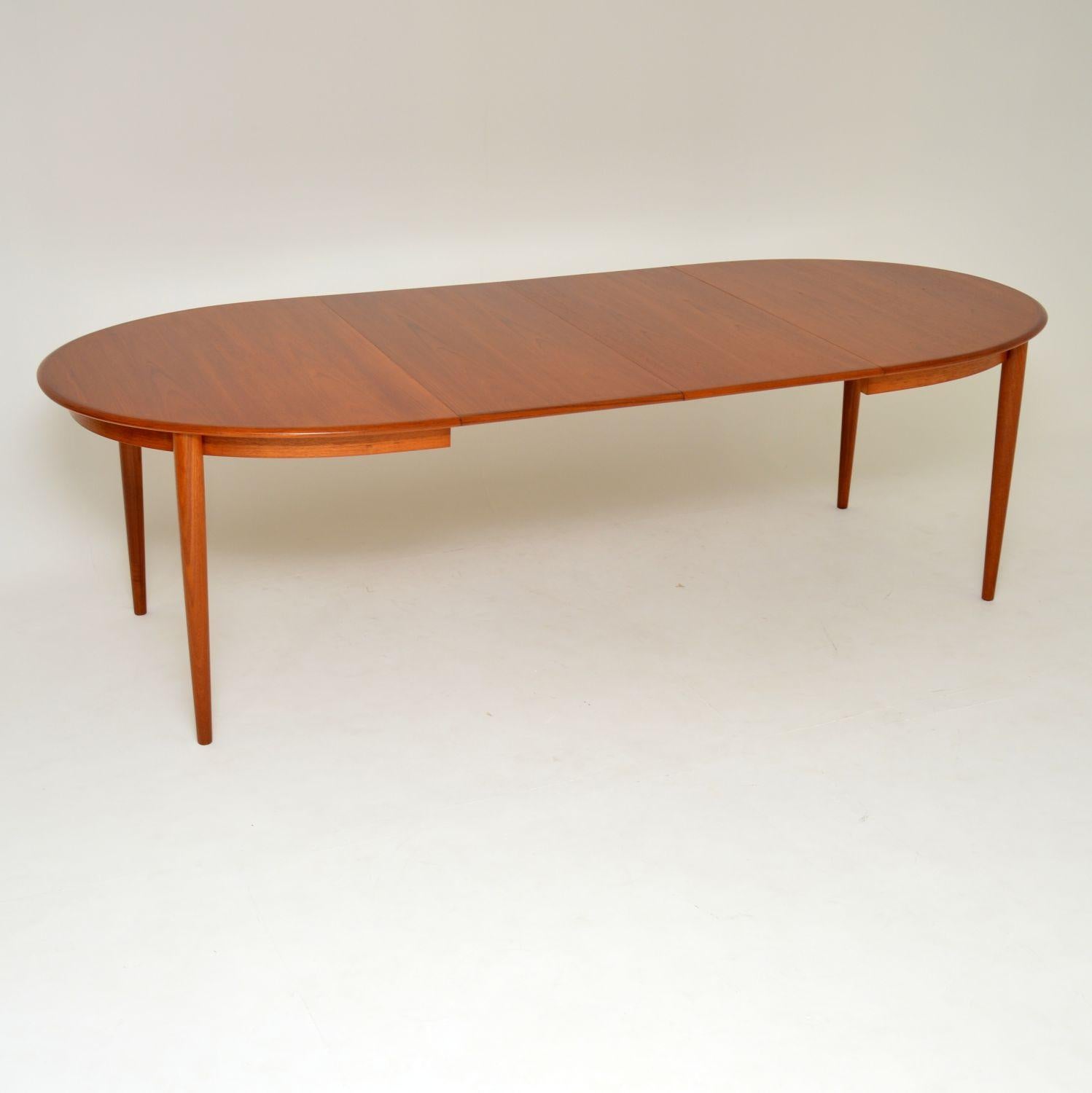 A stunning and top quality vintage Danish dining table in teak. This dates from the 1960s-1970s, and is in superb condition throughout. We have had this stripped and re-polished to a very high standard. There are two extra leaves that come with