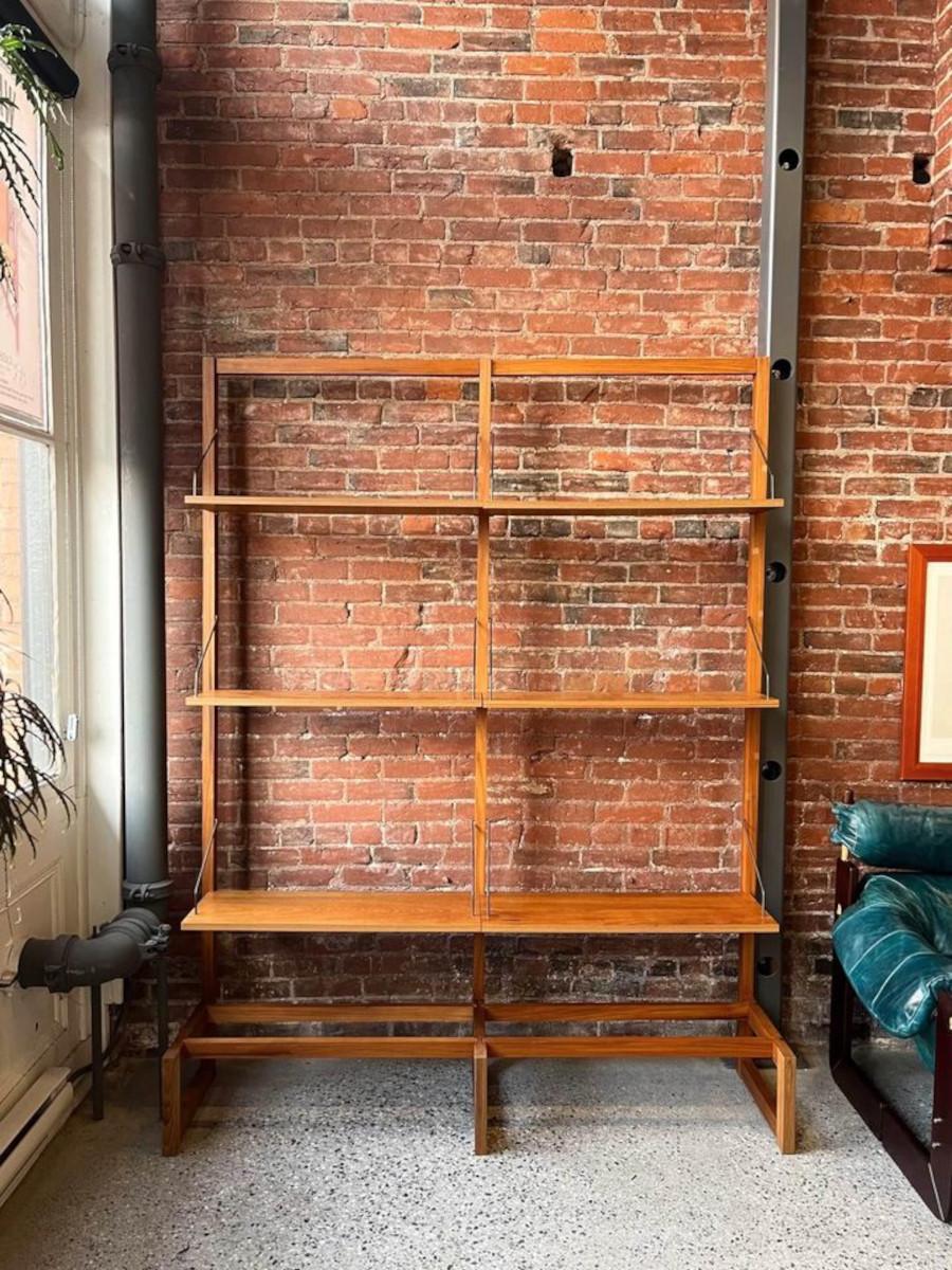 Fresh to the market we have an elegant 1960's Danish teak freestanding shelving system. Crafted with precision, its fully modular design exudes sophistication, complemented by its graceful brass hardware and impeccable dovetail joinery. Meticulously