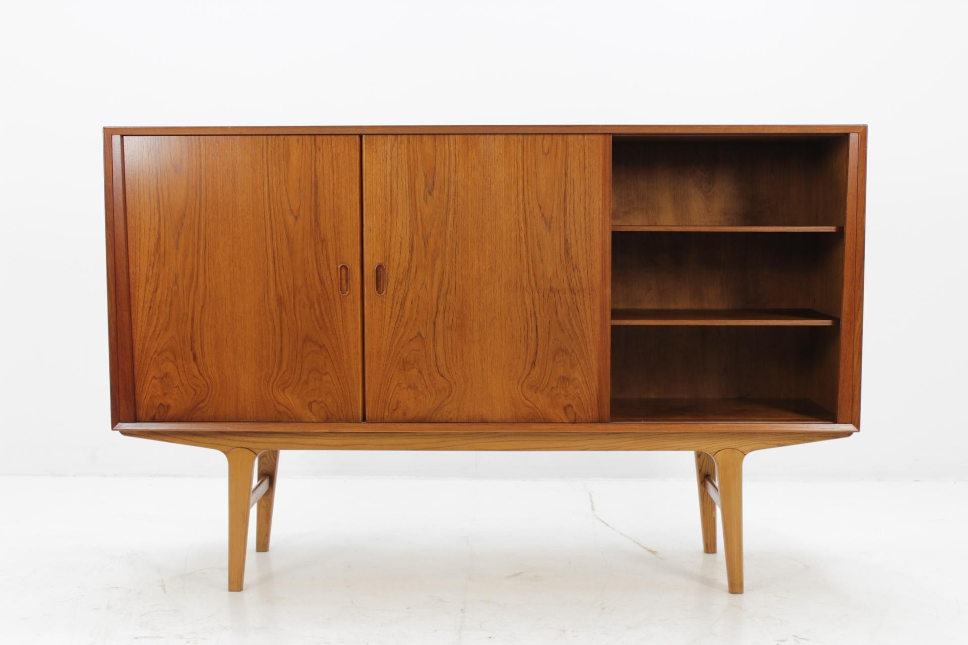 This sideboard features two sliding doors with adjustable shelves and three drawers and one door compartment. This item was carefully restored.