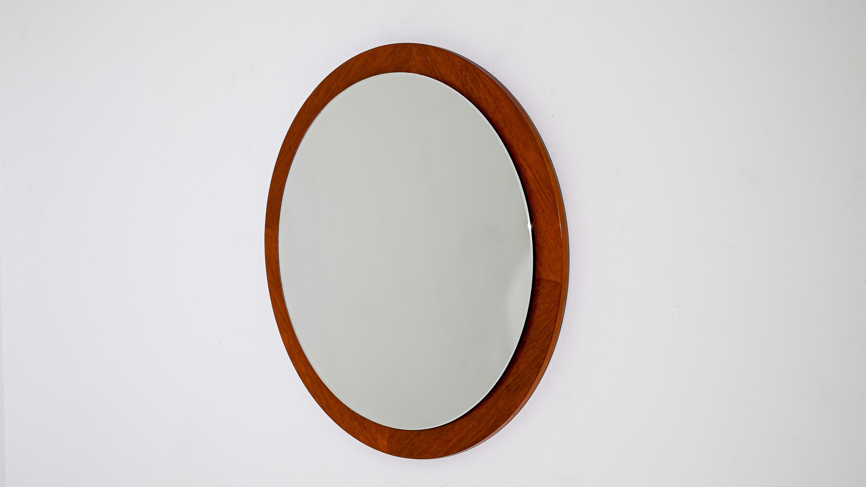 Elevate your space with the timeless elegance of this 1960s Danish Teak Mirror, a true icon of mid-century design. Crafted from rich teak wood, the mirror frame exudes warmth and sophistication, showcasing the natural beauty of the wood grain. The