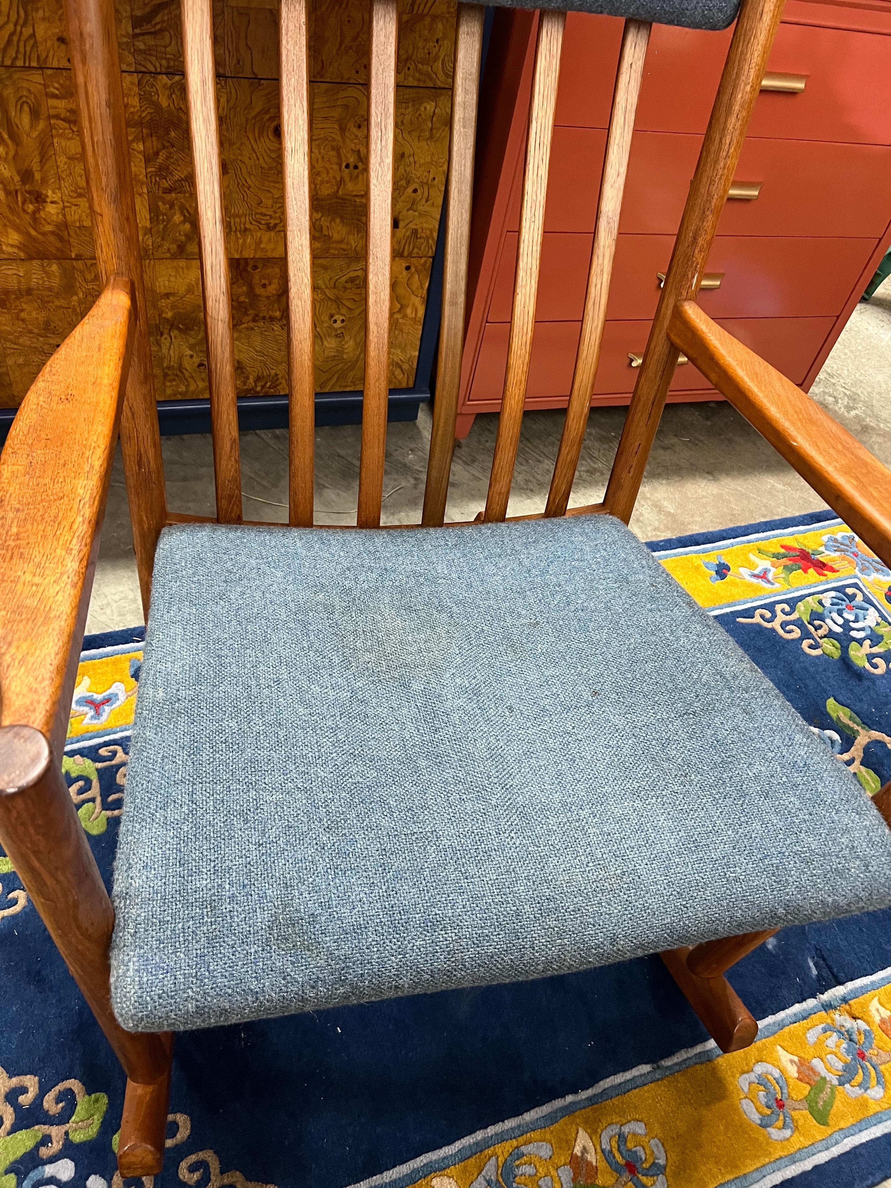 Solid teak rocking chair by Hans Wegner for Tarm Stole OG Mobelfabrik. Made in Denmark and in good vintage condition. Padded seat and a padded headrest held in place by leather straps. Very comfortable and has a good rock. Classic Danish Modern