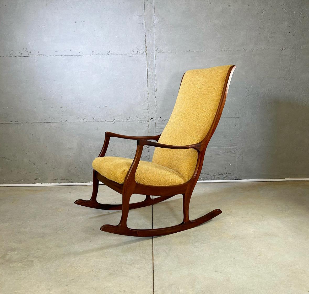 This Danish rocking chair from the 1960s is a stunning example of Scandinavian craftsmanship, combining timeless design with comfort. Crafted from solid teakwood, the chair showcases elegant wood details, including gracefully curved arms and a